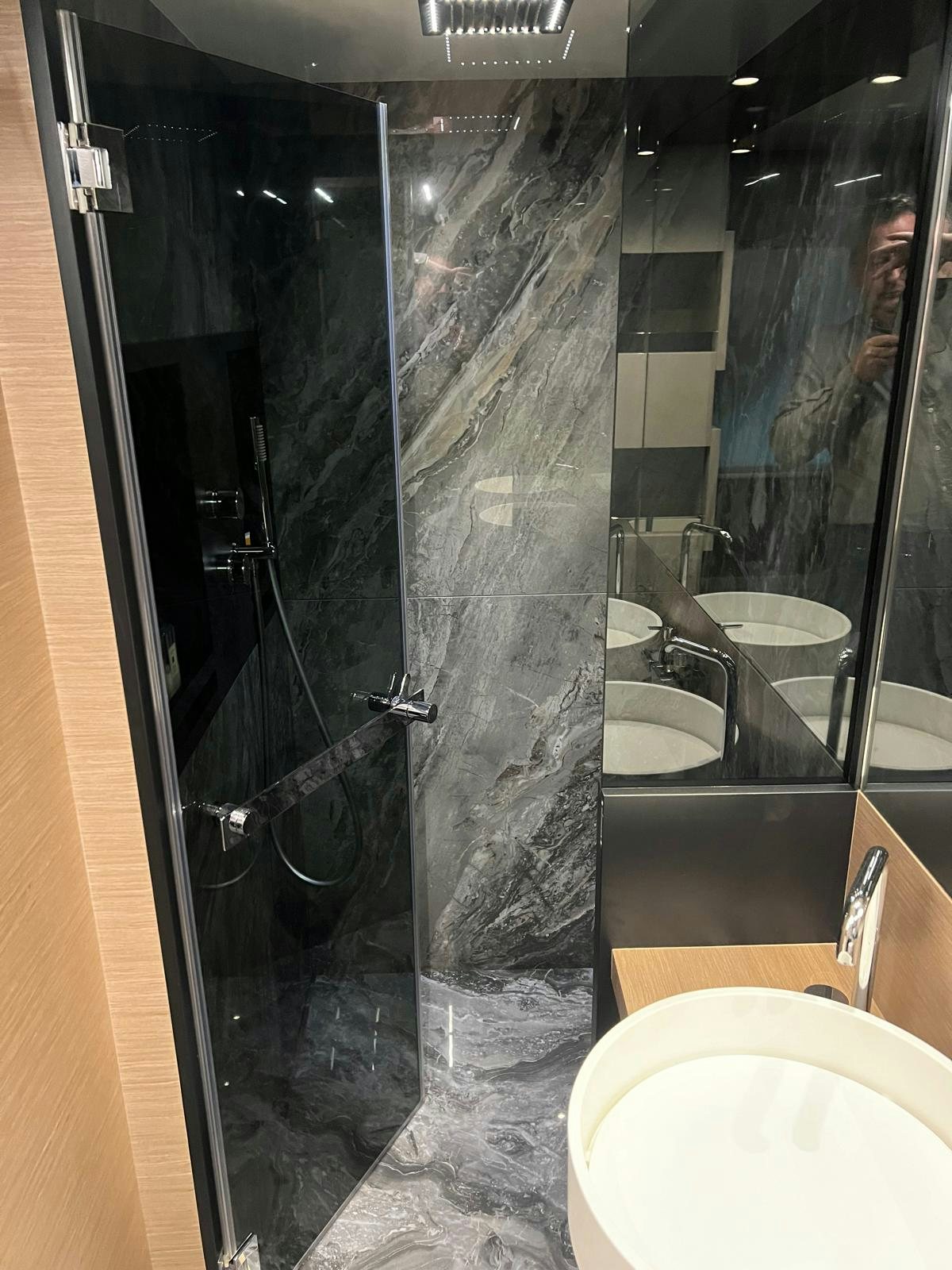 a bathroom with a glass shower aboard PICCOLINO Yacht for Sale
