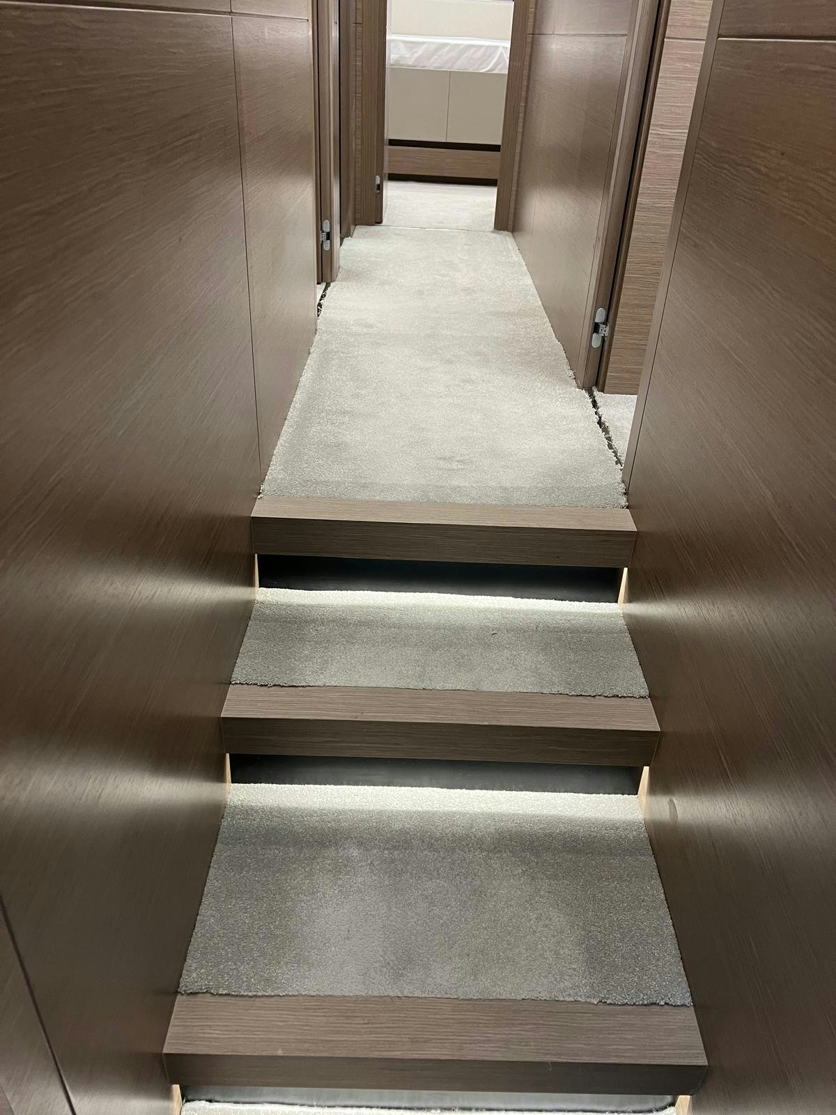 a wooden staircase in a room aboard PICCOLINO Yacht for Sale