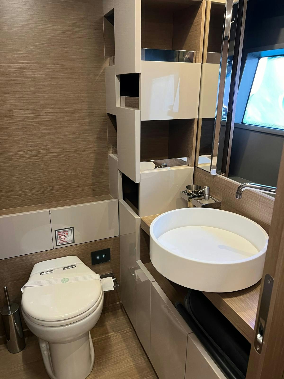 a bathroom with a sink and toilet aboard PICCOLINO Yacht for Sale