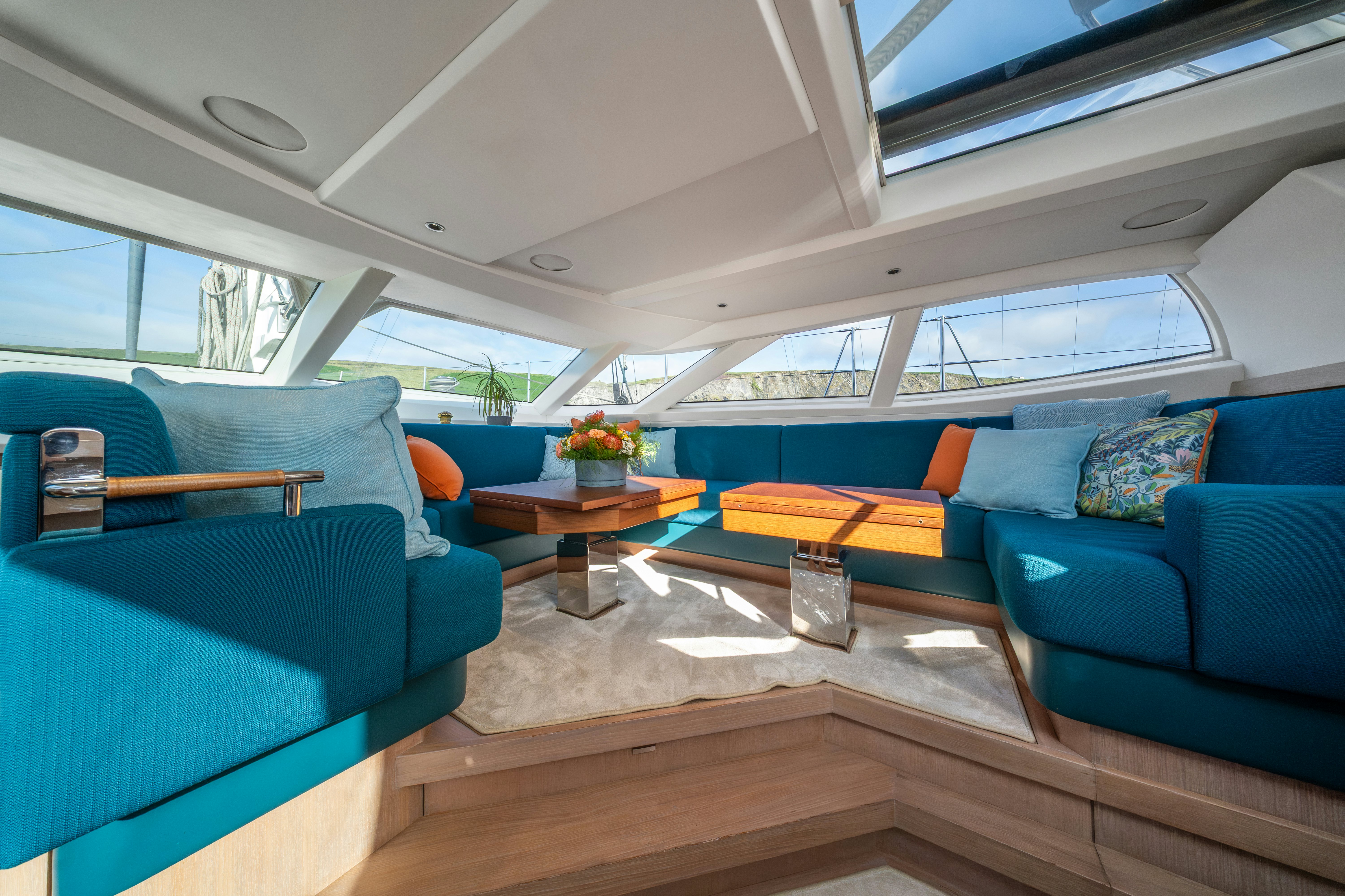 a room with couches and a table aboard KARIBU Yacht for Sale
