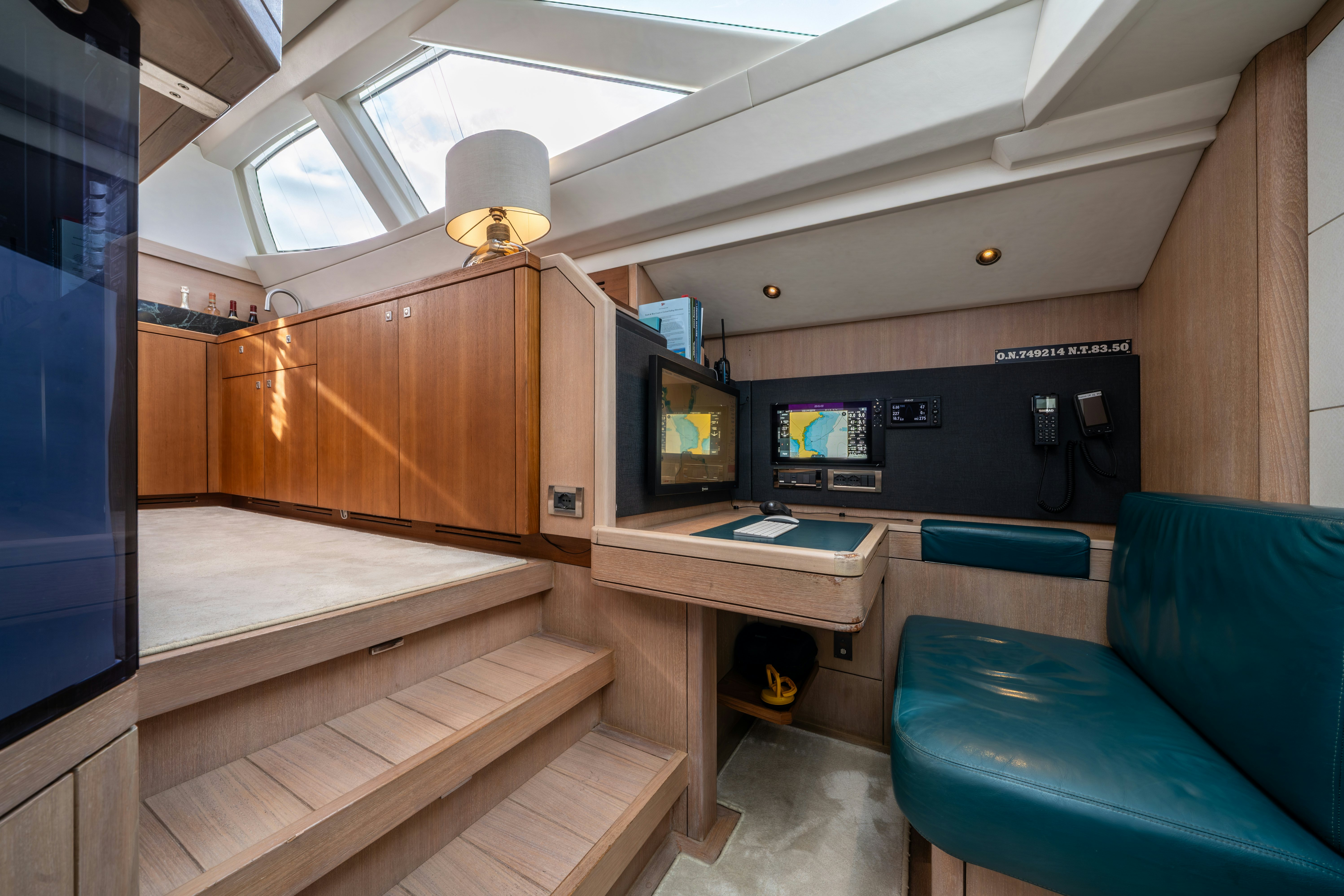 a room with a couch and a desk with a computer on it aboard KARIBU Yacht for Sale