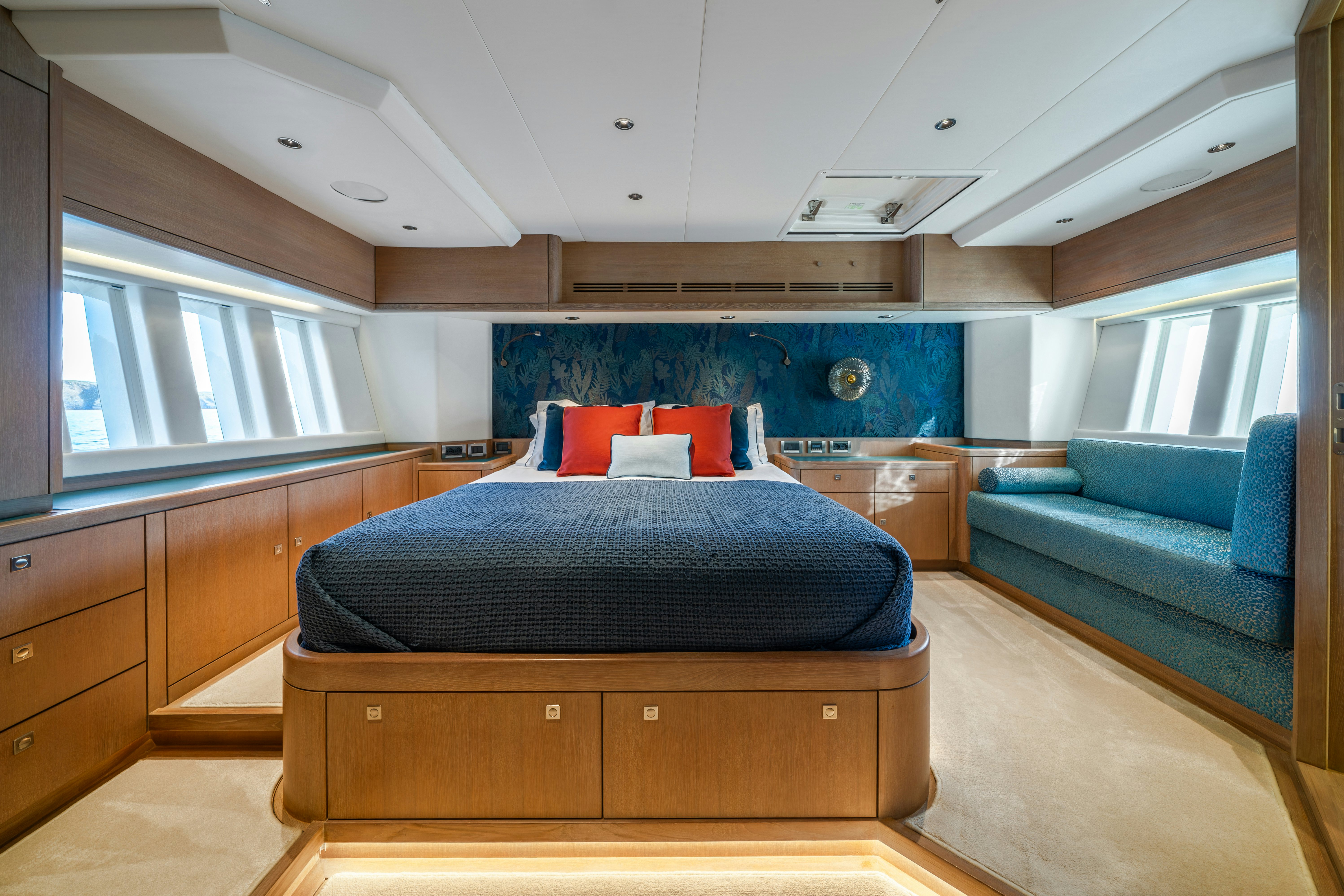 a bedroom with a bed and a couch aboard KARIBU Yacht for Sale