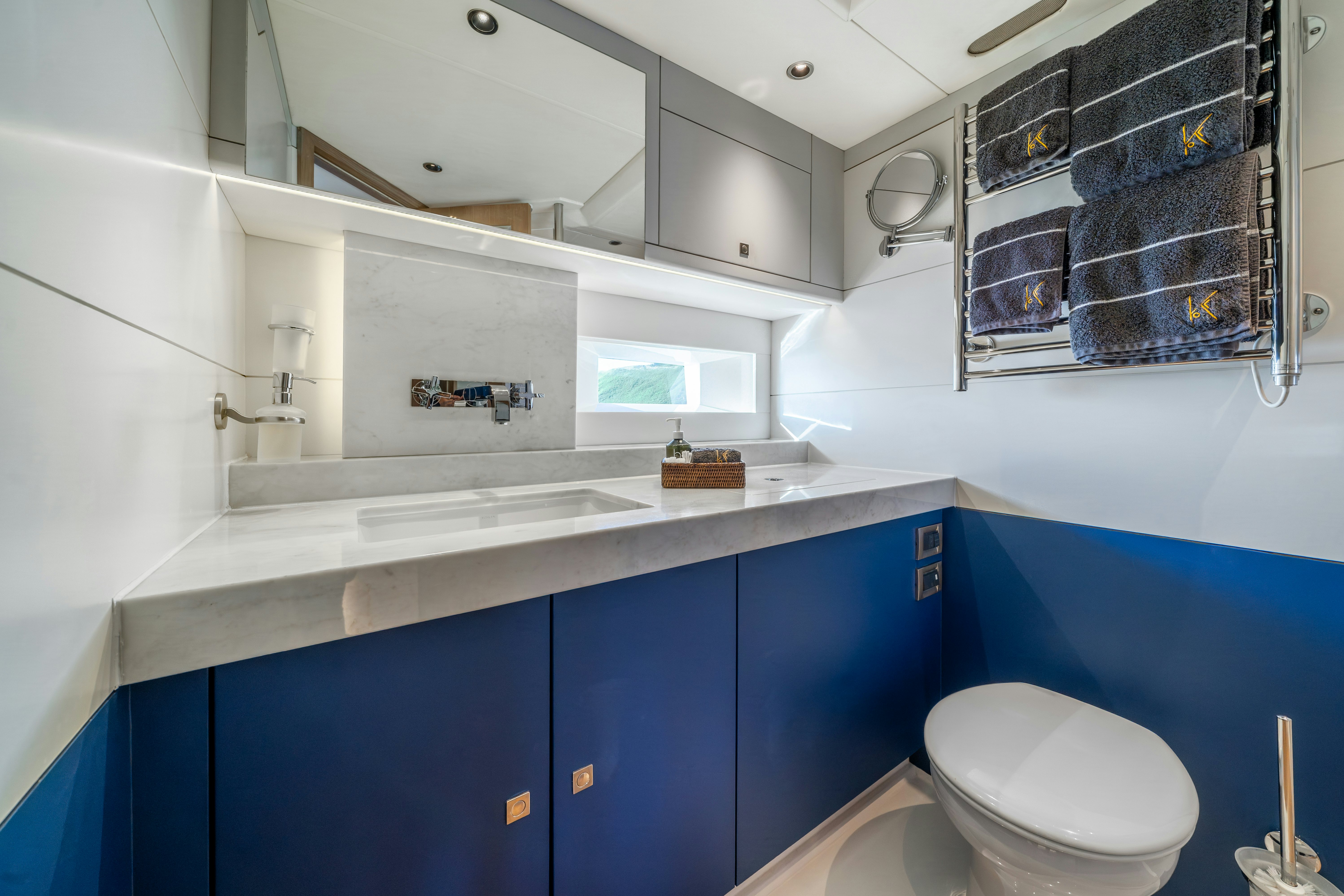 a bathroom with blue cabinets aboard KARIBU Yacht for Sale