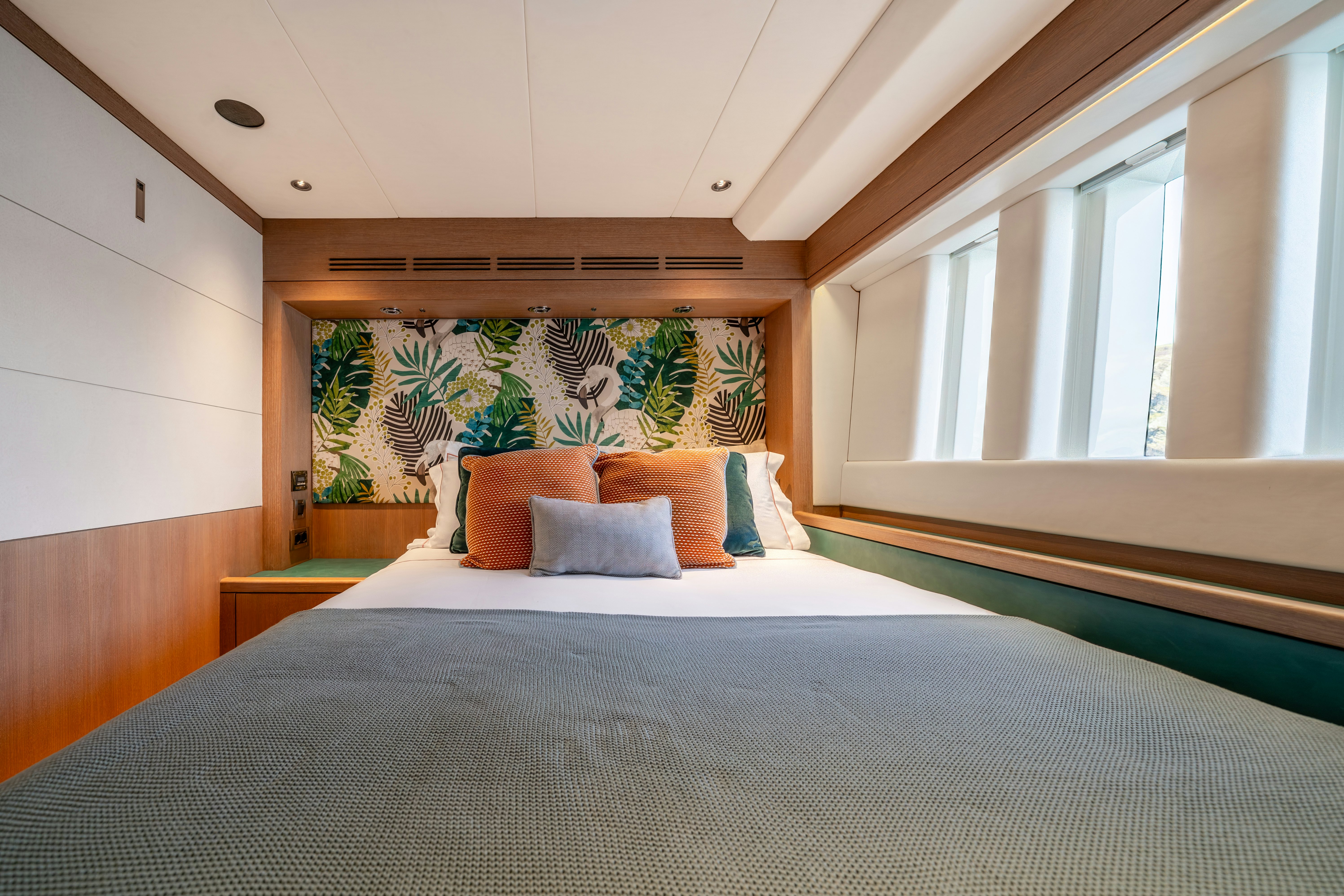 a bed with a painting on the wall aboard KARIBU Yacht for Sale