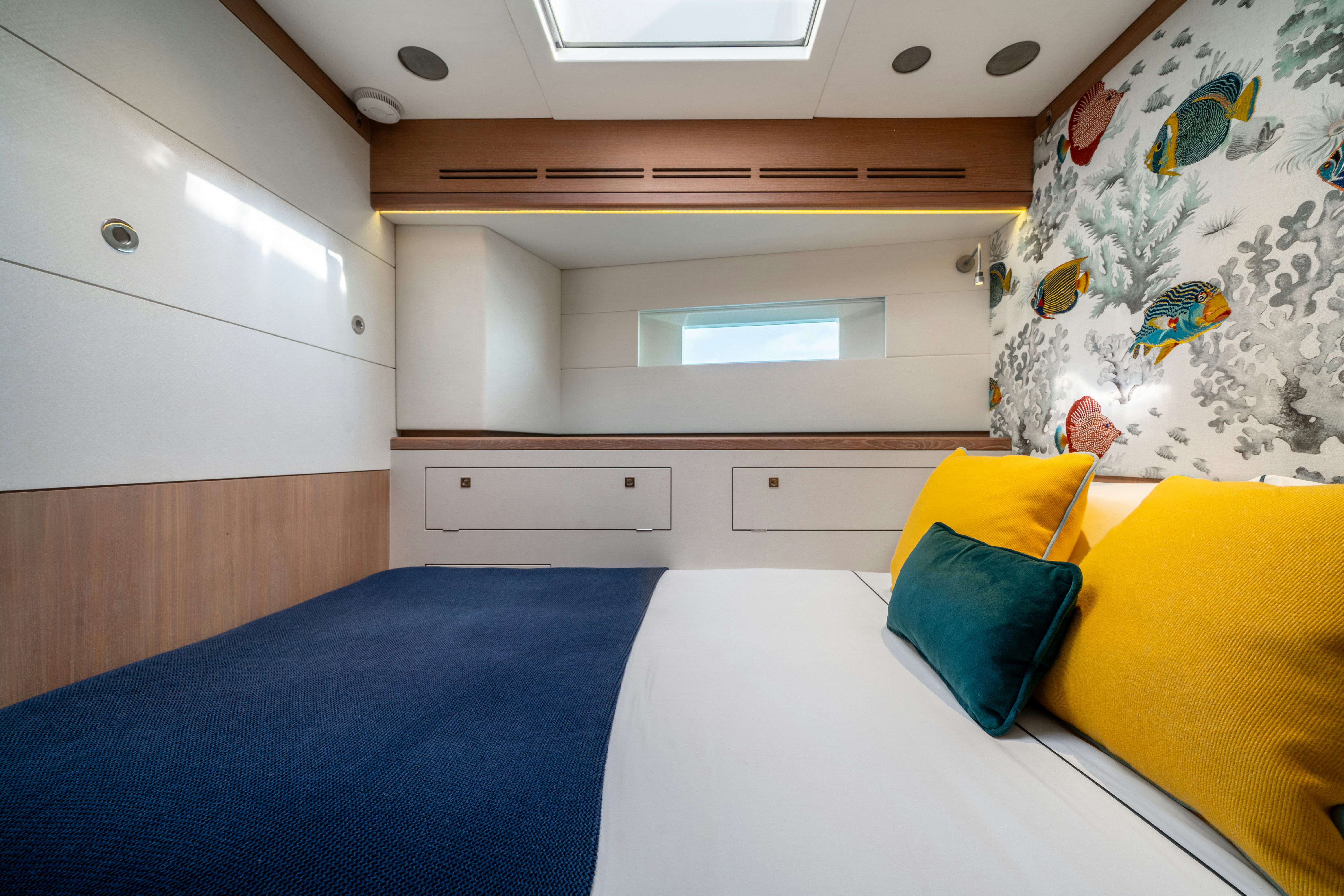 a room with a bed and a desk aboard KARIBU Yacht for Sale
