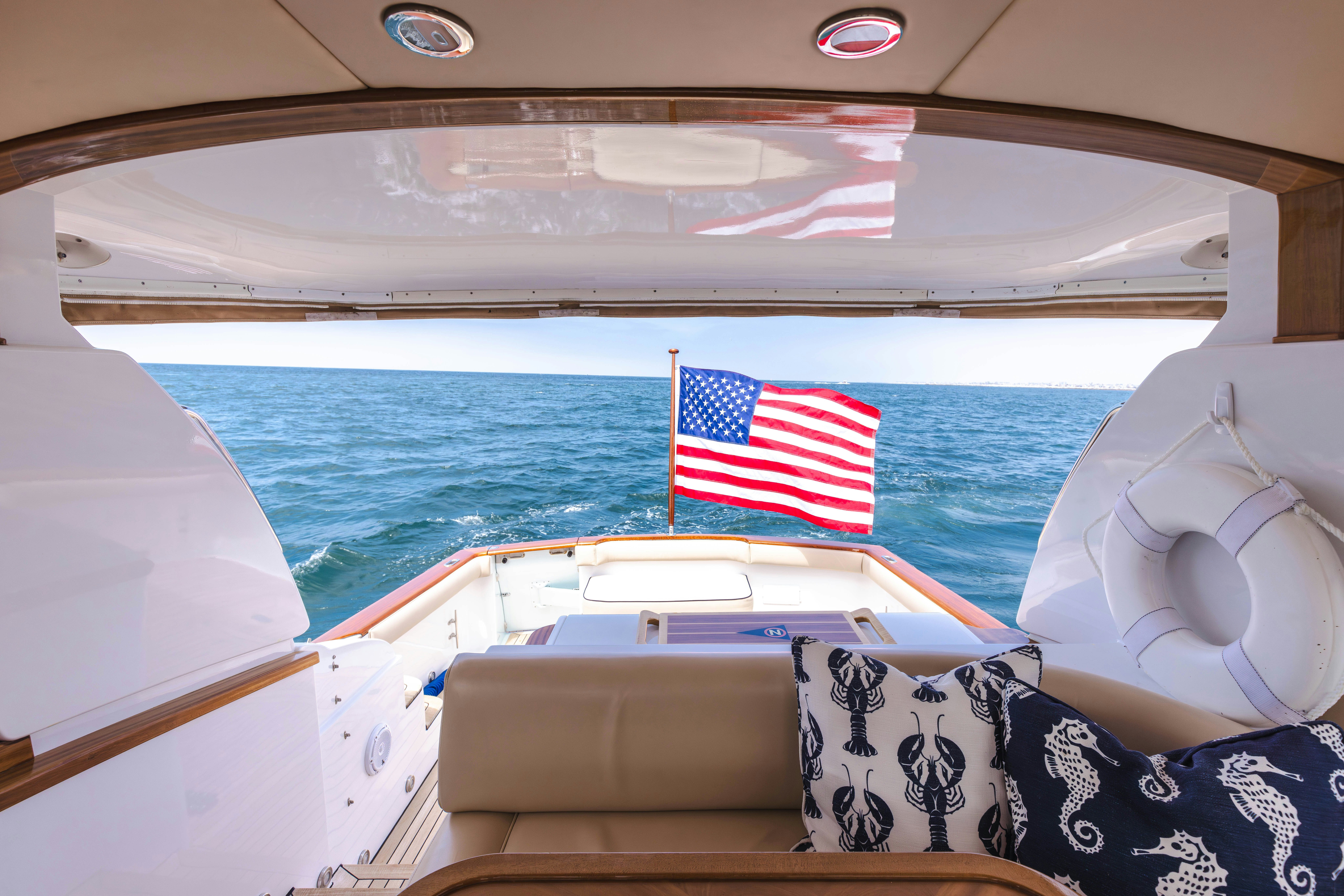 a flag on the back of a boat aboard TRANQUILITY Yacht for Sale