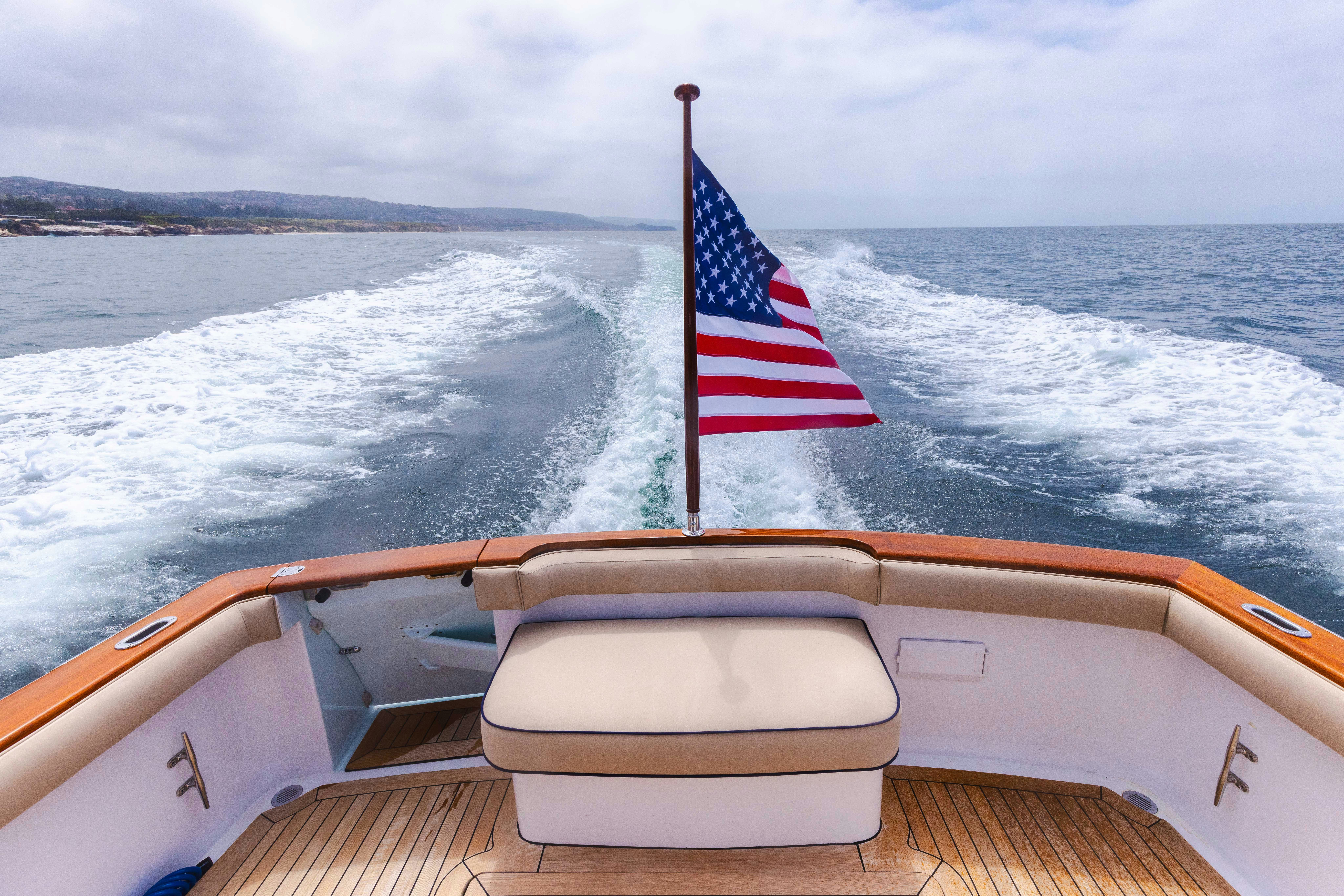 a boat with a flag on the front aboard TRANQUILITY Yacht for Sale