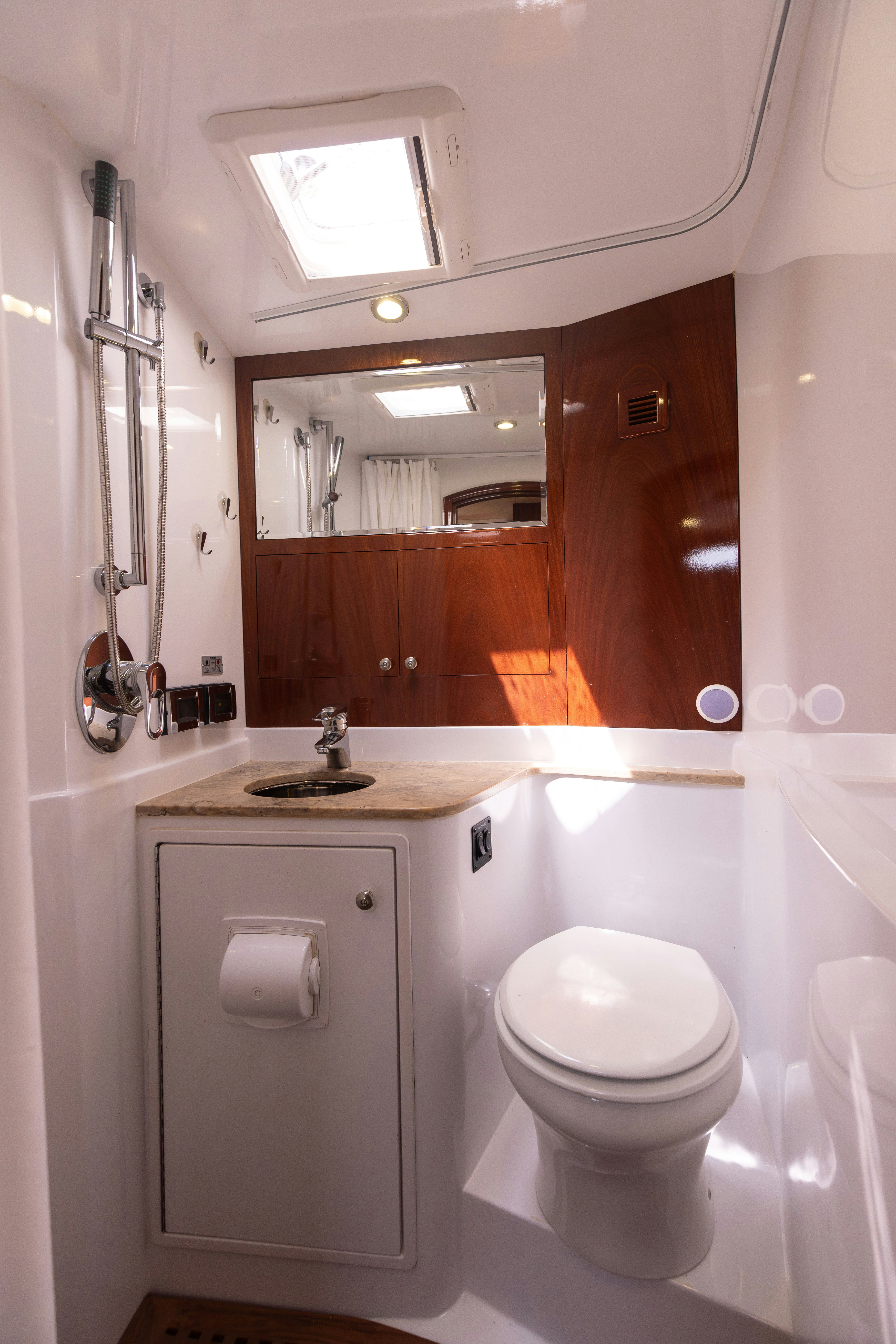 a bathroom with a toilet and a sink aboard TRANQUILITY Yacht for Sale