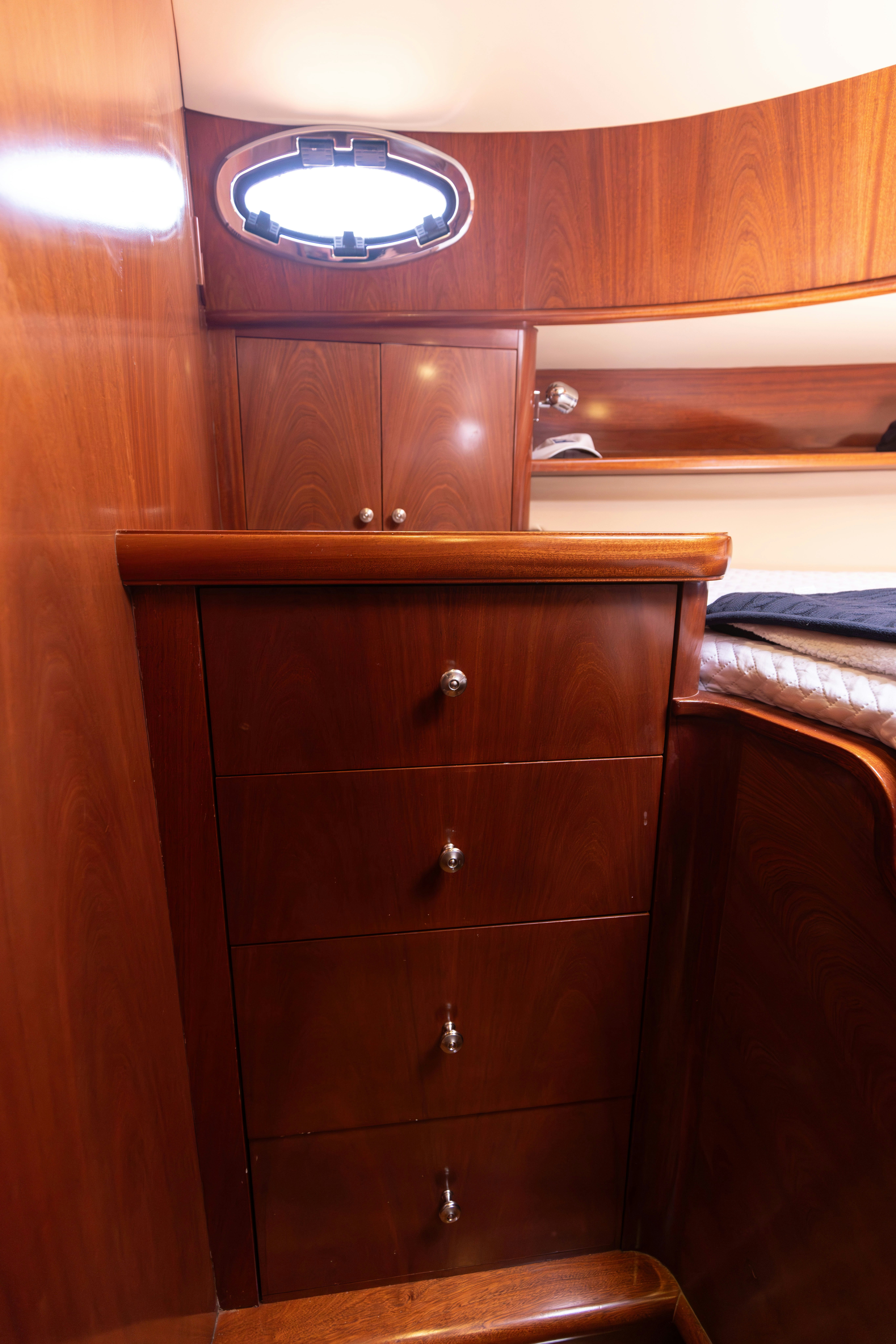 a wooden cabinet with a light above it aboard TRANQUILITY Yacht for Sale