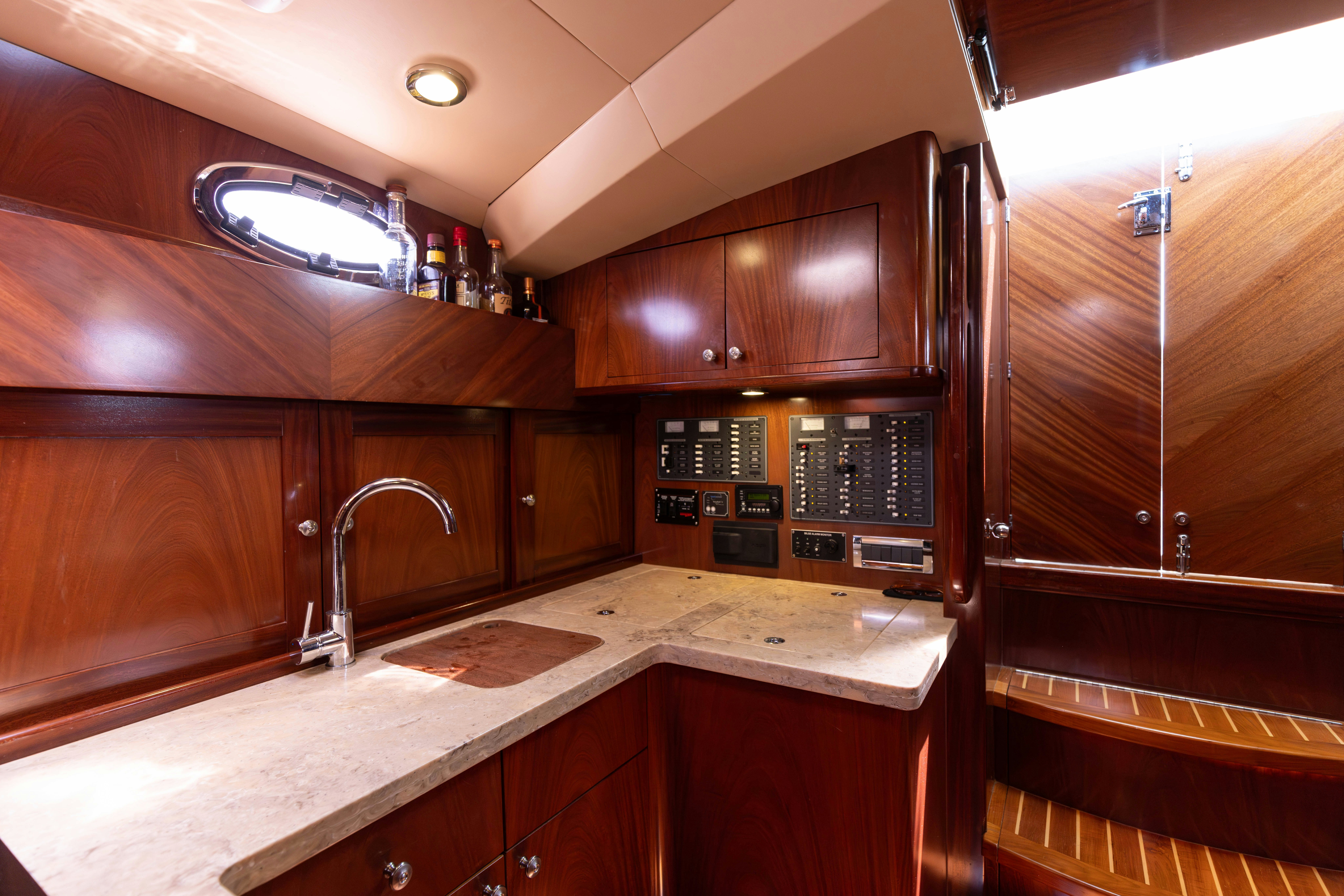 a kitchen with wooden cabinets aboard TRANQUILITY Yacht for Sale