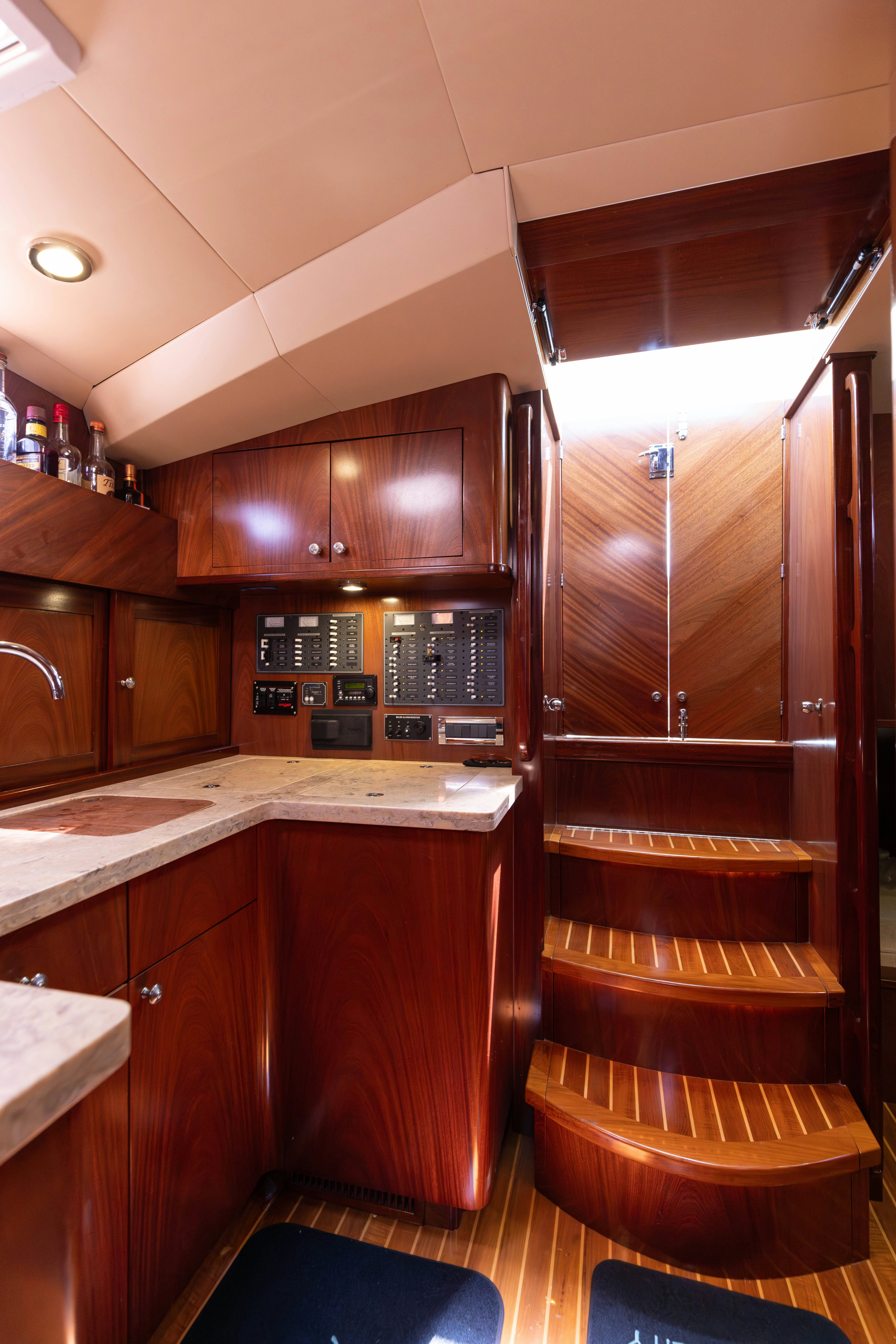 a kitchen with wooden cabinets aboard TRANQUILITY Yacht for Sale