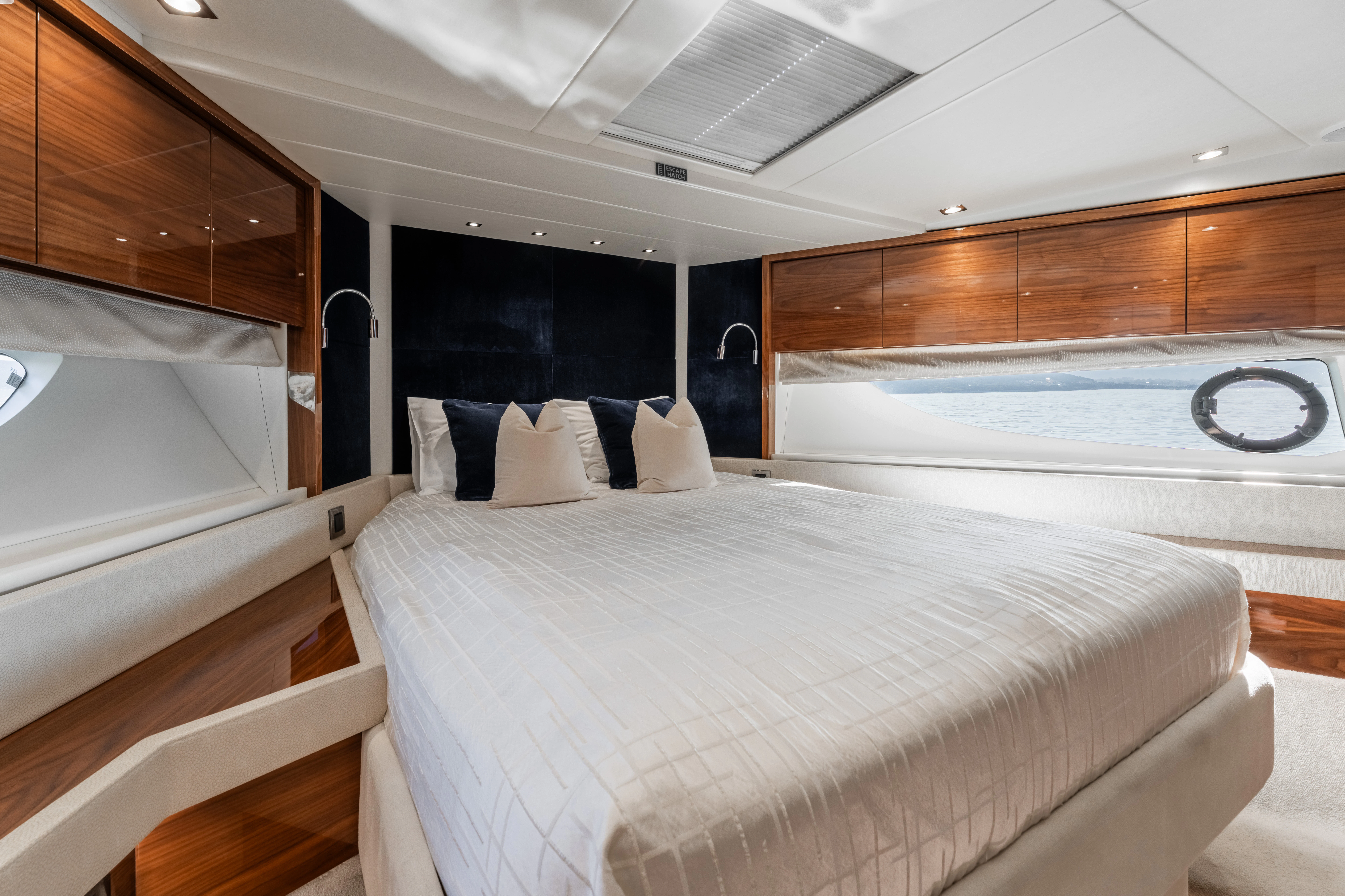 a room with a bed and a wood wall aboard TOP LEVEL Yacht for Sale