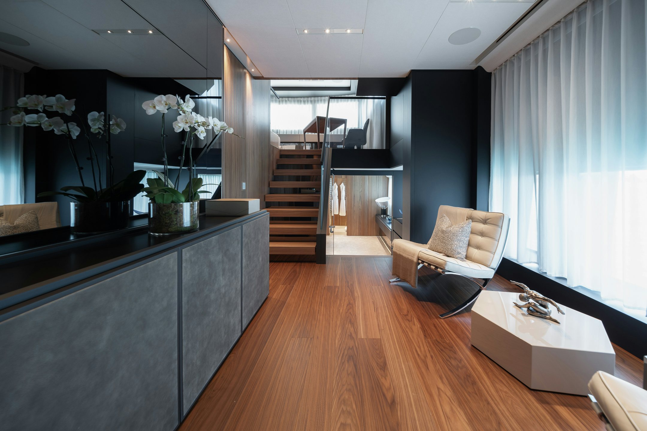 a room with a wood floor and a staircase aboard AIX Yacht for Charter