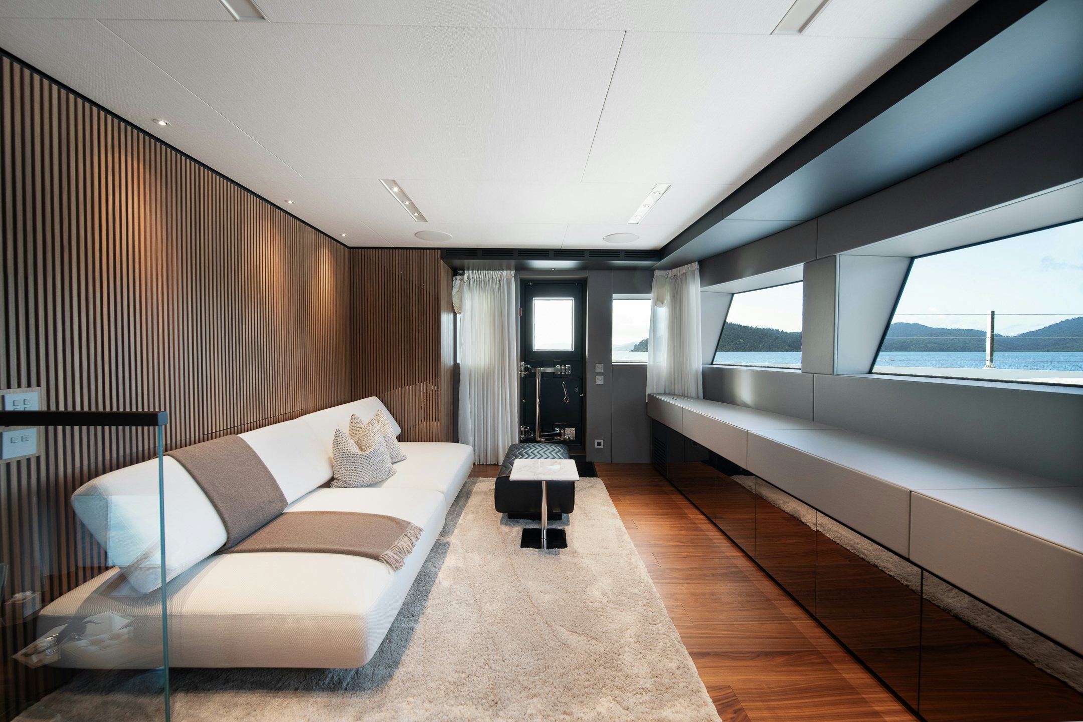 a room with a bed and a window aboard AIX Yacht for Charter