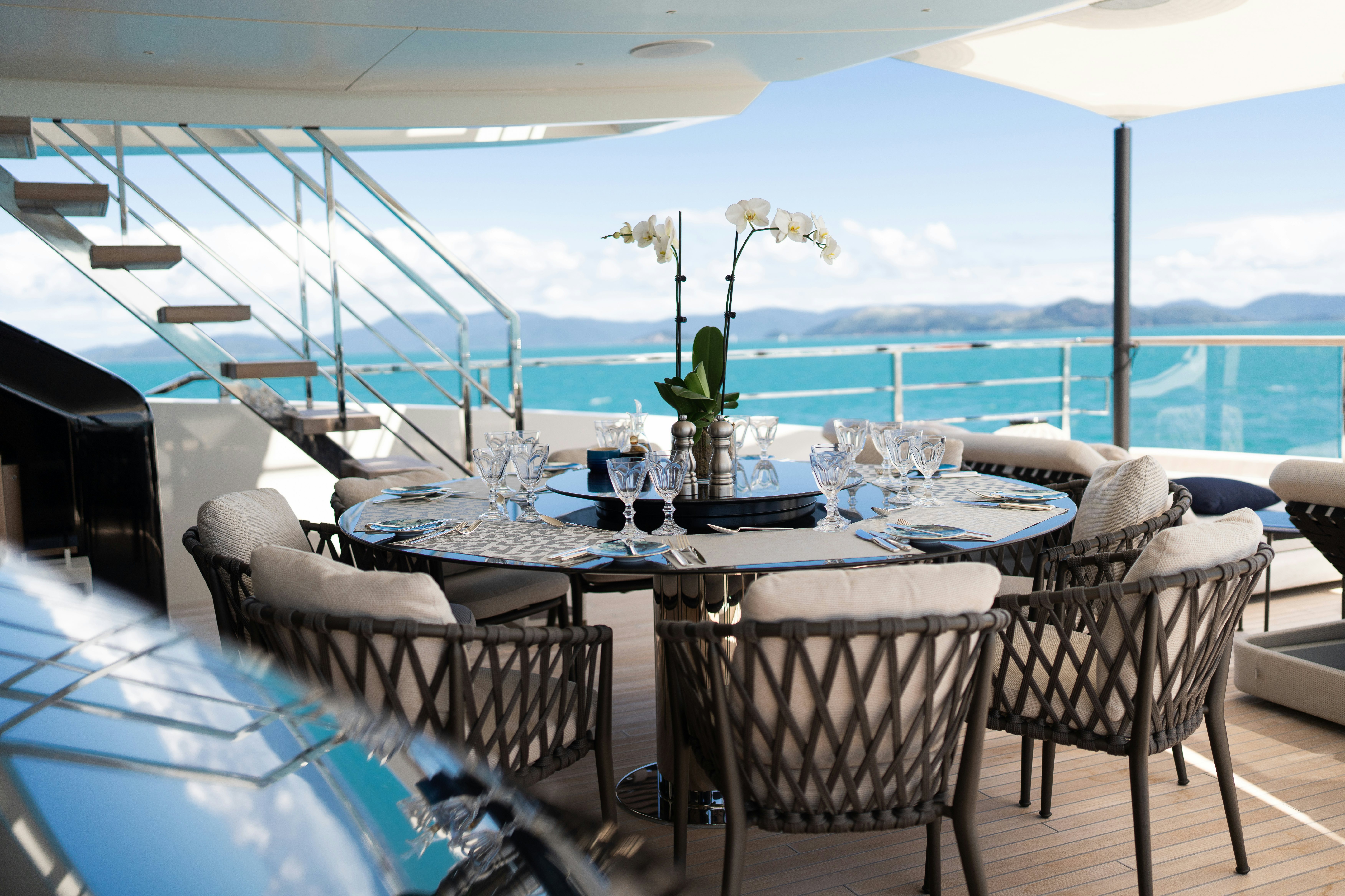 a table set for a dinner aboard AIX Yacht for Charter