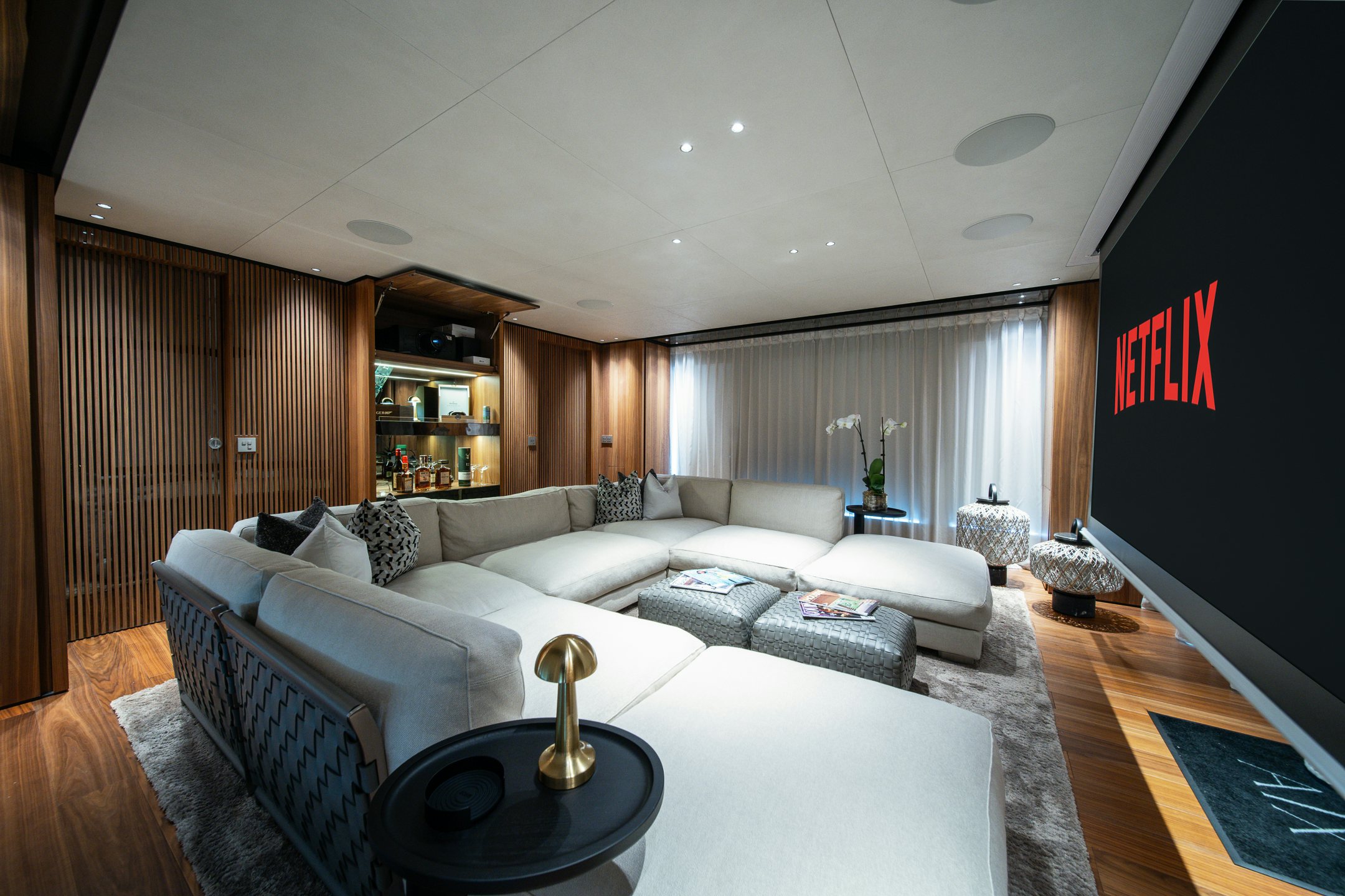 a living room with a large screen aboard AIX Yacht for Charter
