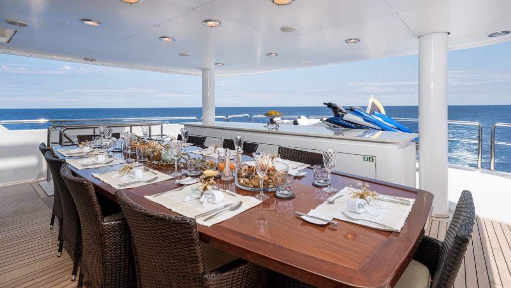 a table with wine glasses on it aboard IONIAN PRINCESS Yacht for Sale