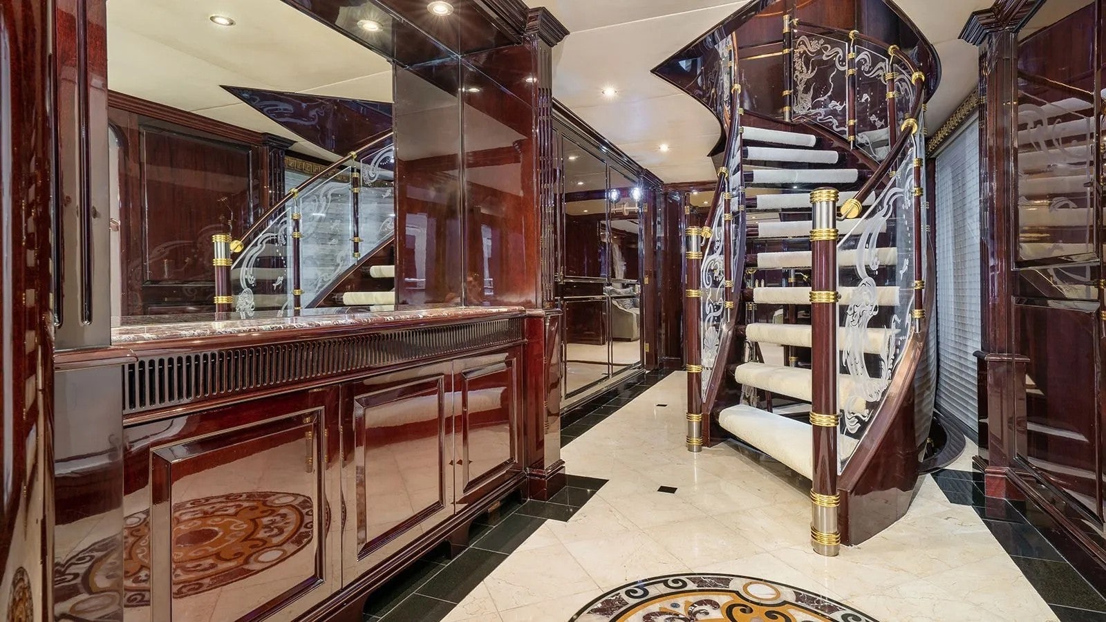 a large room with a staircase and a large glass case aboard IONIAN PRINCESS Yacht for Sale