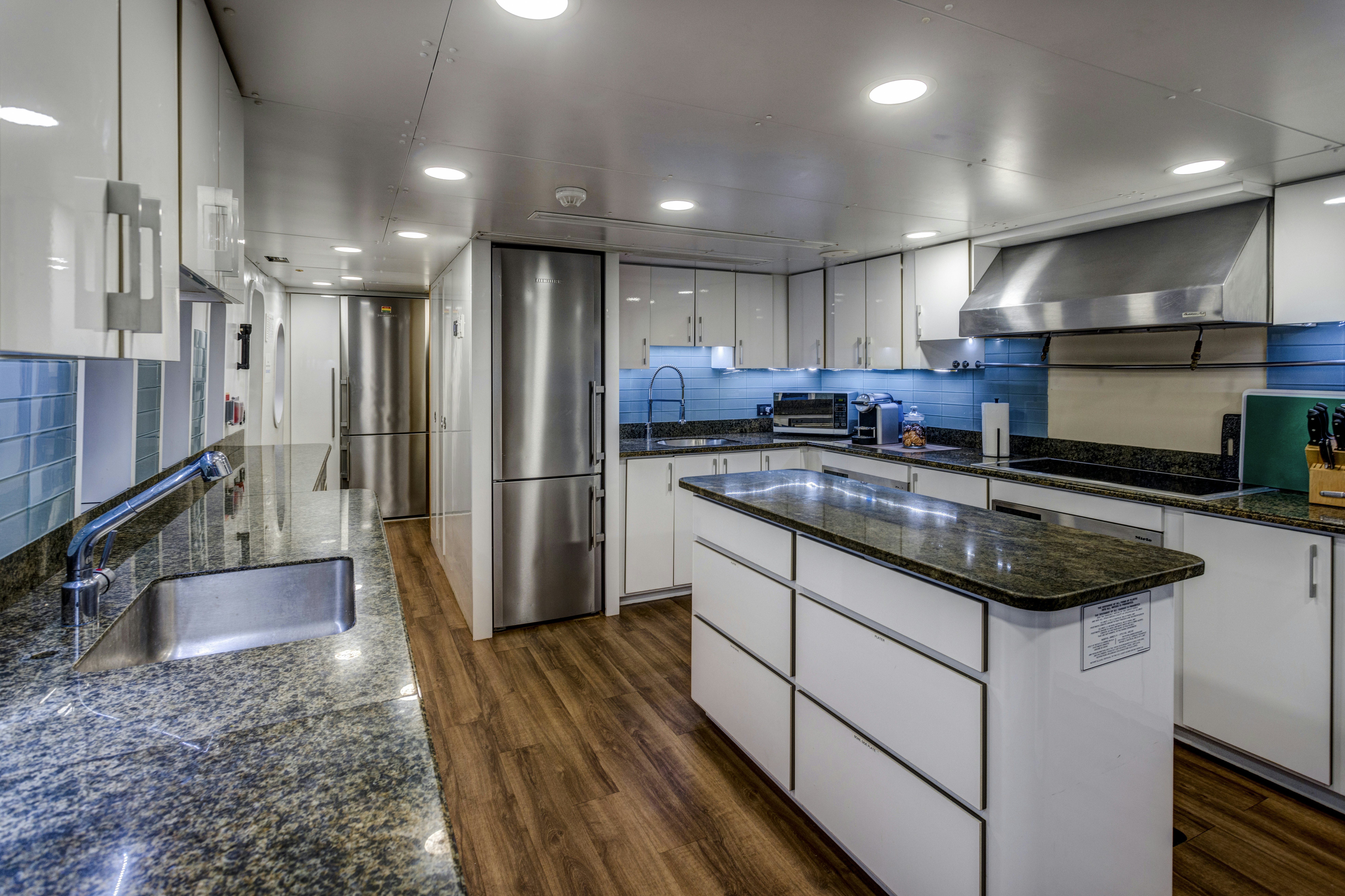 a kitchen with a stainless steel refrigerator aboard IONIAN PRINCESS Yacht for Sale