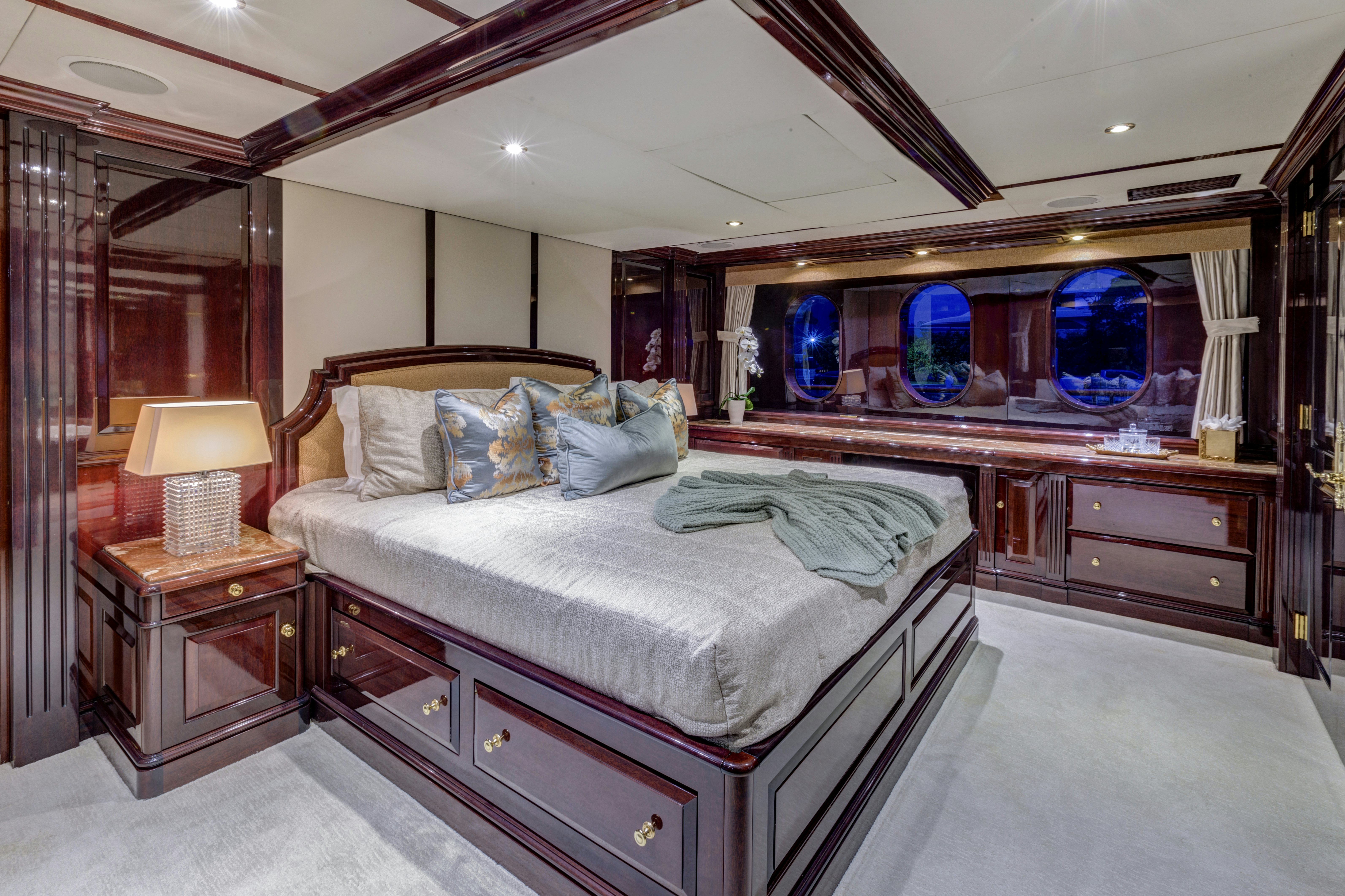 a bedroom with a bed and a dresser aboard IONIAN PRINCESS Yacht for Sale