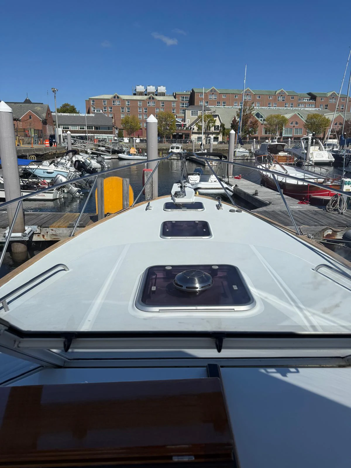 a white yacht in a harbor aboard LARK Yacht for Sale