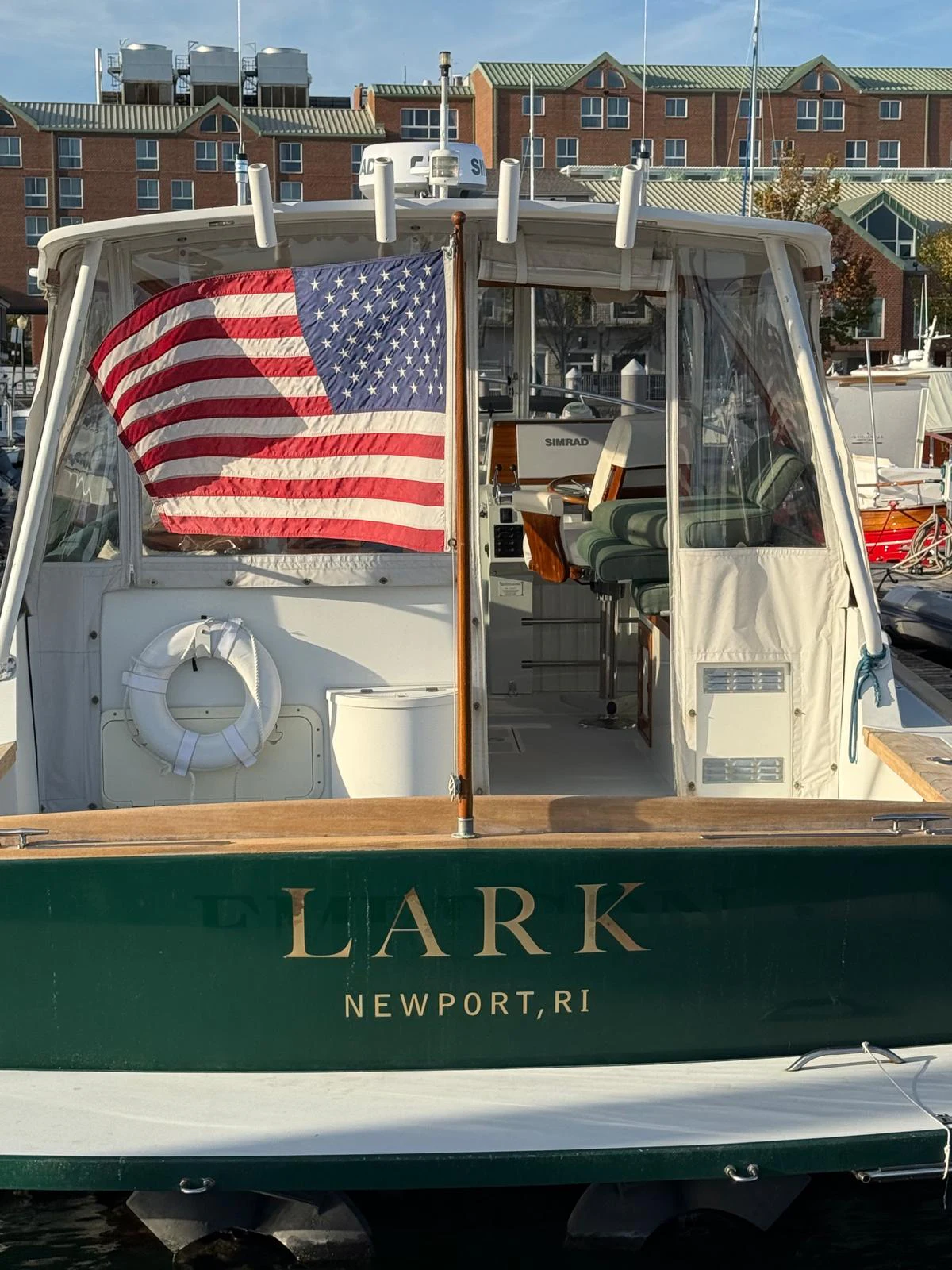 a boat with a flag on the front aboard LARK Yacht for Sale