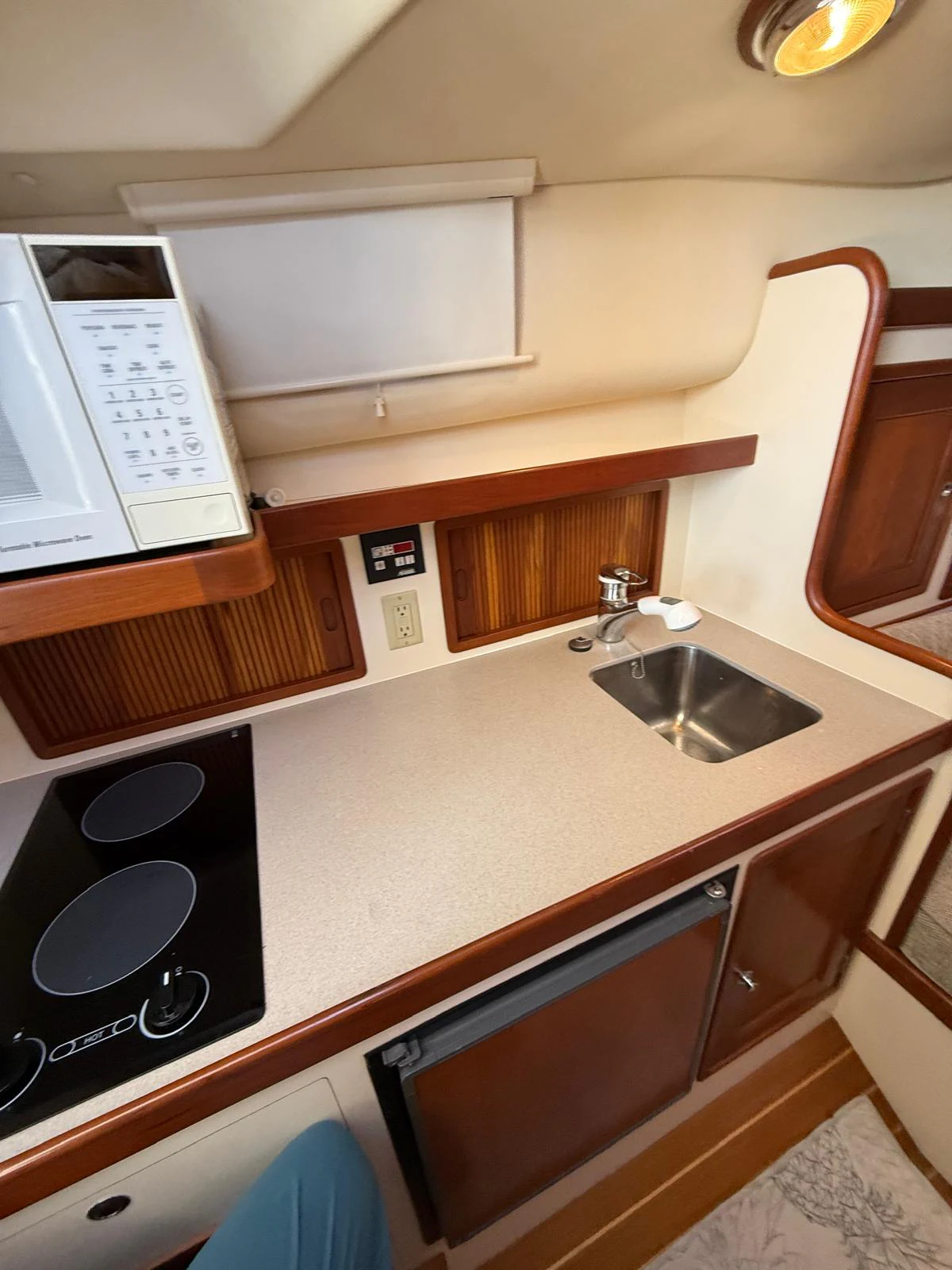 a kitchen with a microwave oven and a sink aboard LARK Yacht for Sale