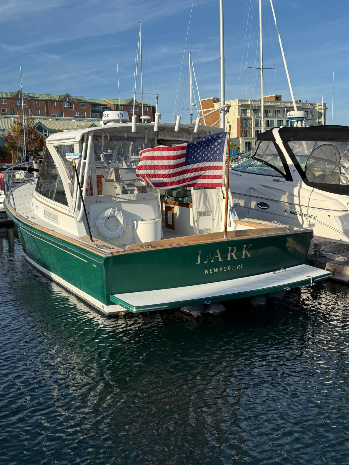 a boat with a flag on the front aboard LARK Yacht for Sale