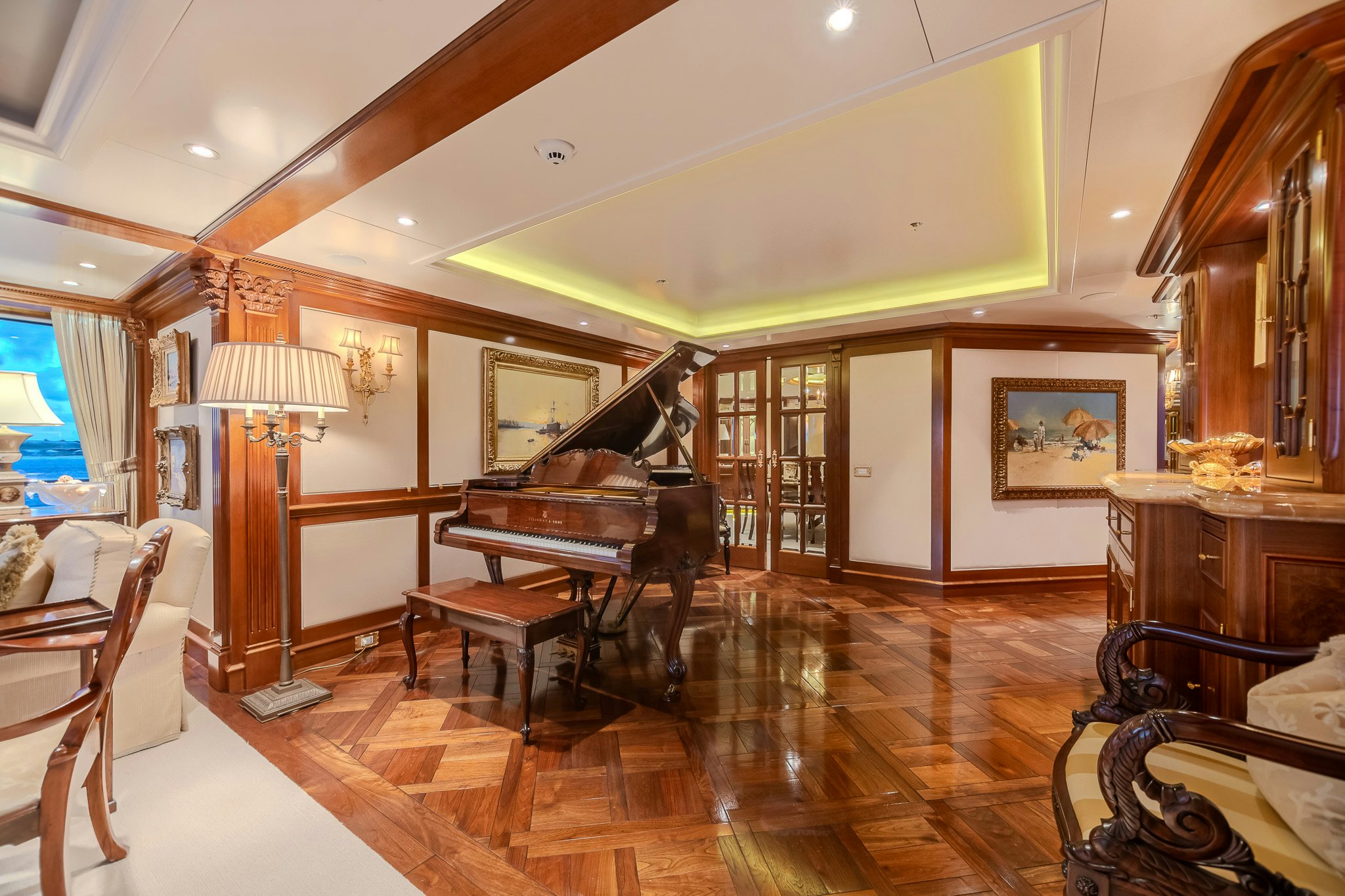 a large room with a piano and a piano aboard LADY KATHRYN V Yacht for Charter