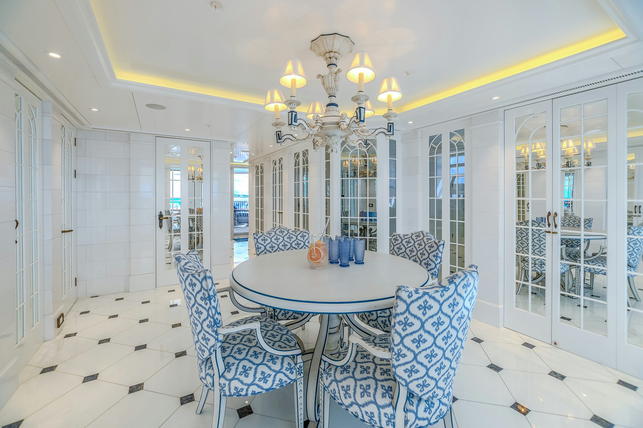 a dining room with a chandelier aboard LADY KATHRYN V Yacht for Charter