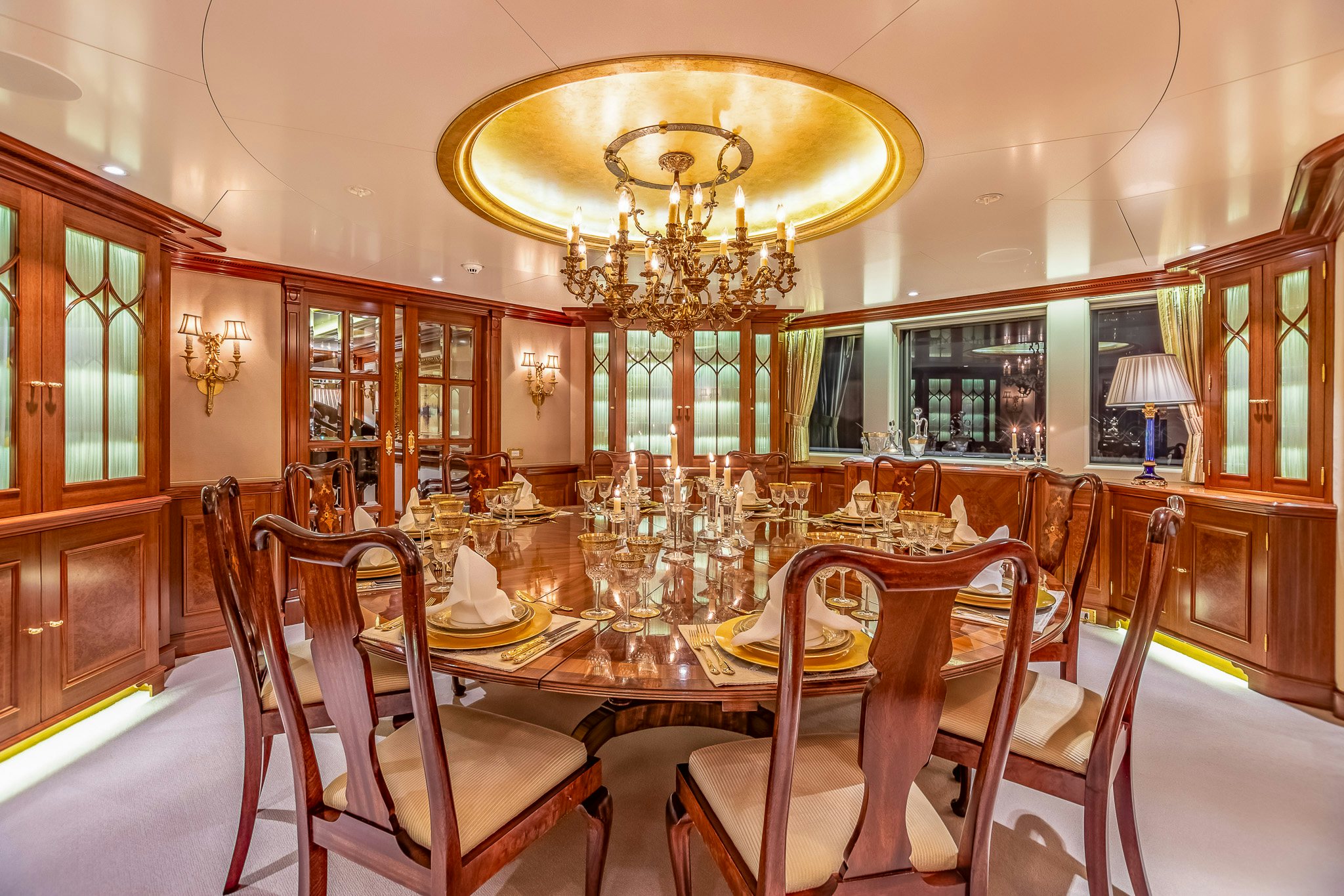 a dining room with a chandelier aboard LADY KATHRYN V Yacht for Charter