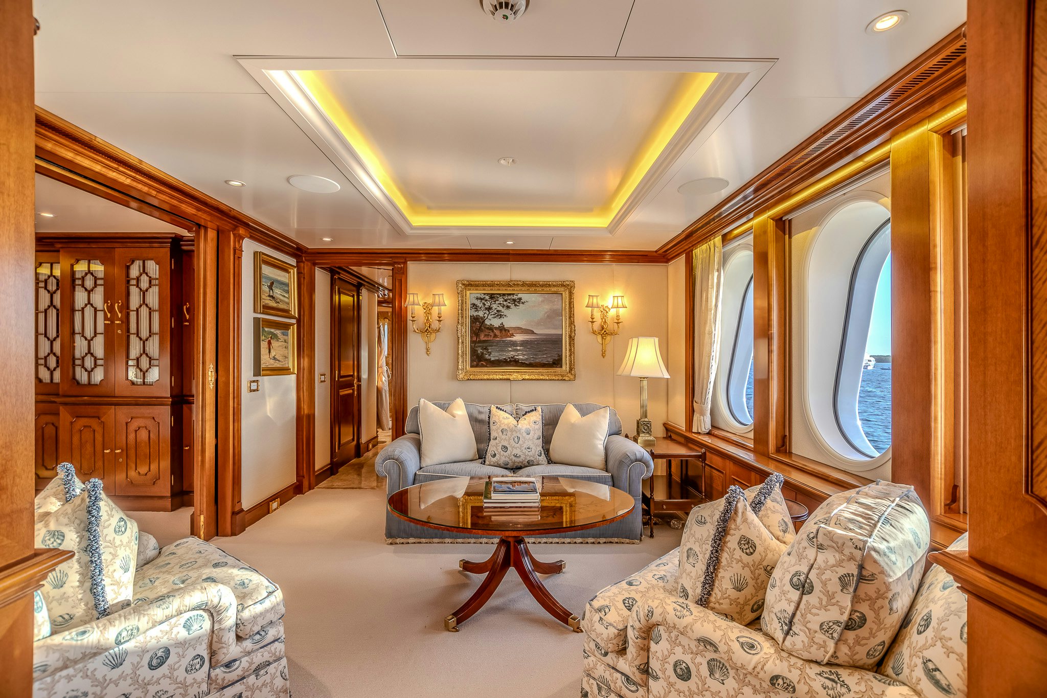 a living room with a couch and a table aboard LADY KATHRYN V Yacht for Charter