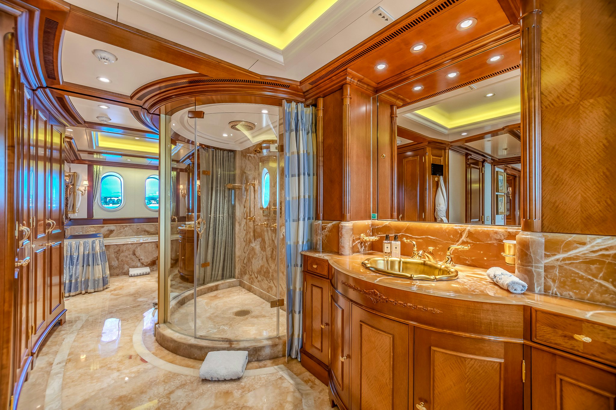 a bathroom with a large mirror aboard LADY KATHRYN V Yacht for Charter