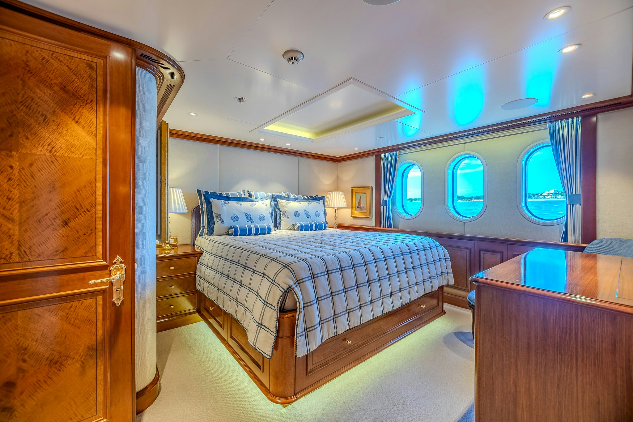 a bedroom with a bed and a desk aboard LADY KATHRYN V Yacht for Charter