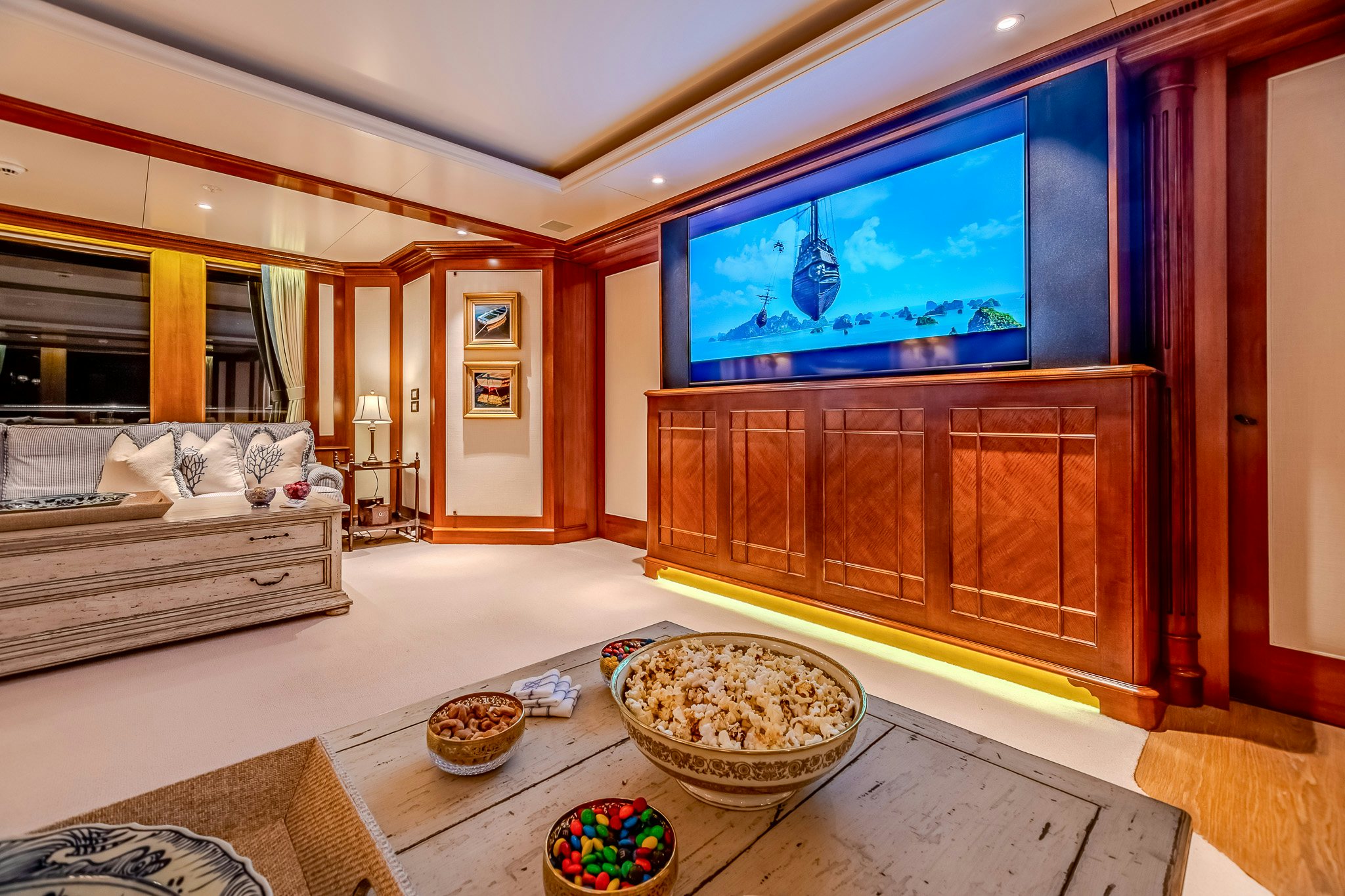 a living room with a large screen aboard LADY KATHRYN V Yacht for Charter