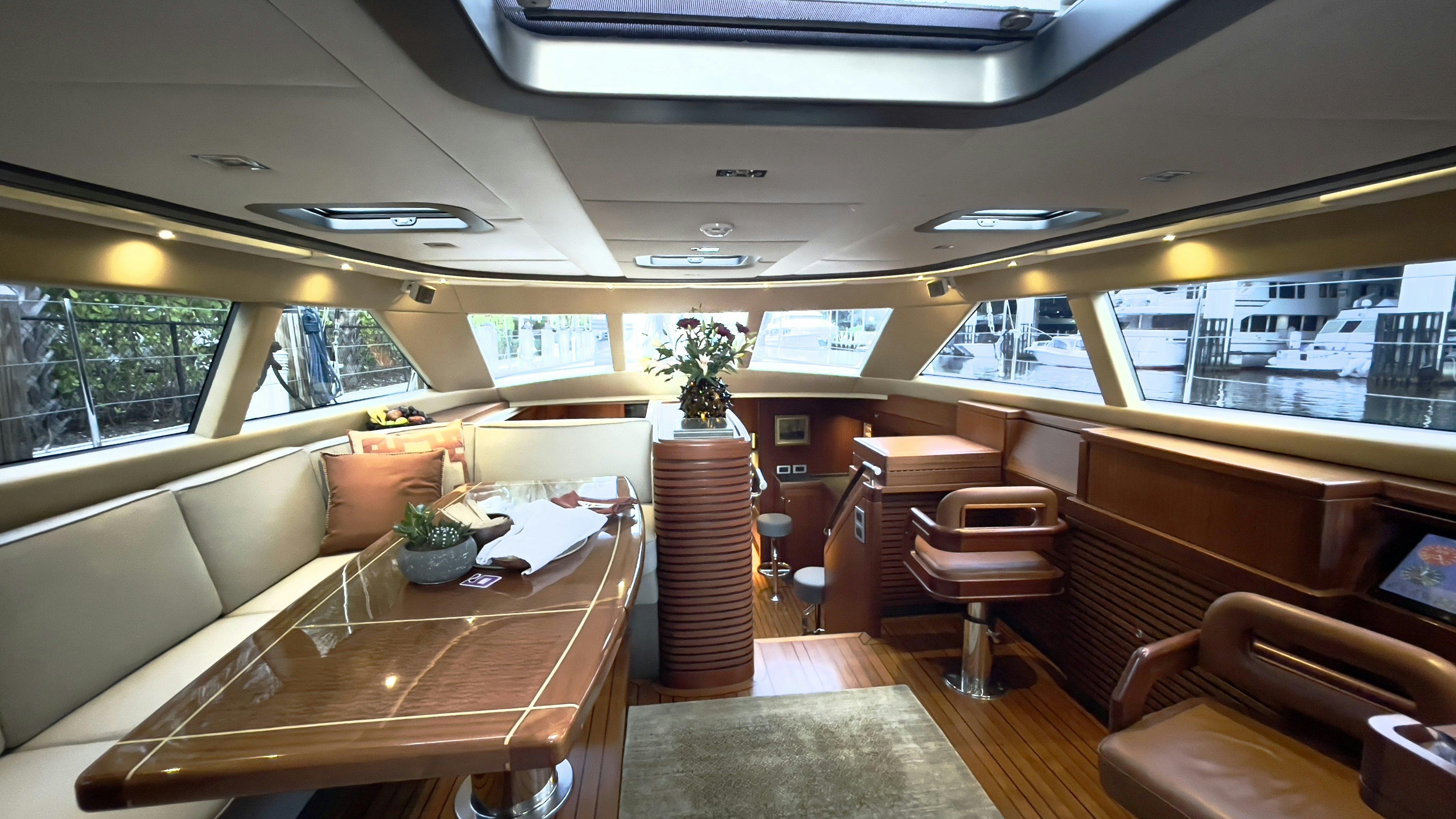 a room with a table and chairs aboard ASSAI Yacht for Sale