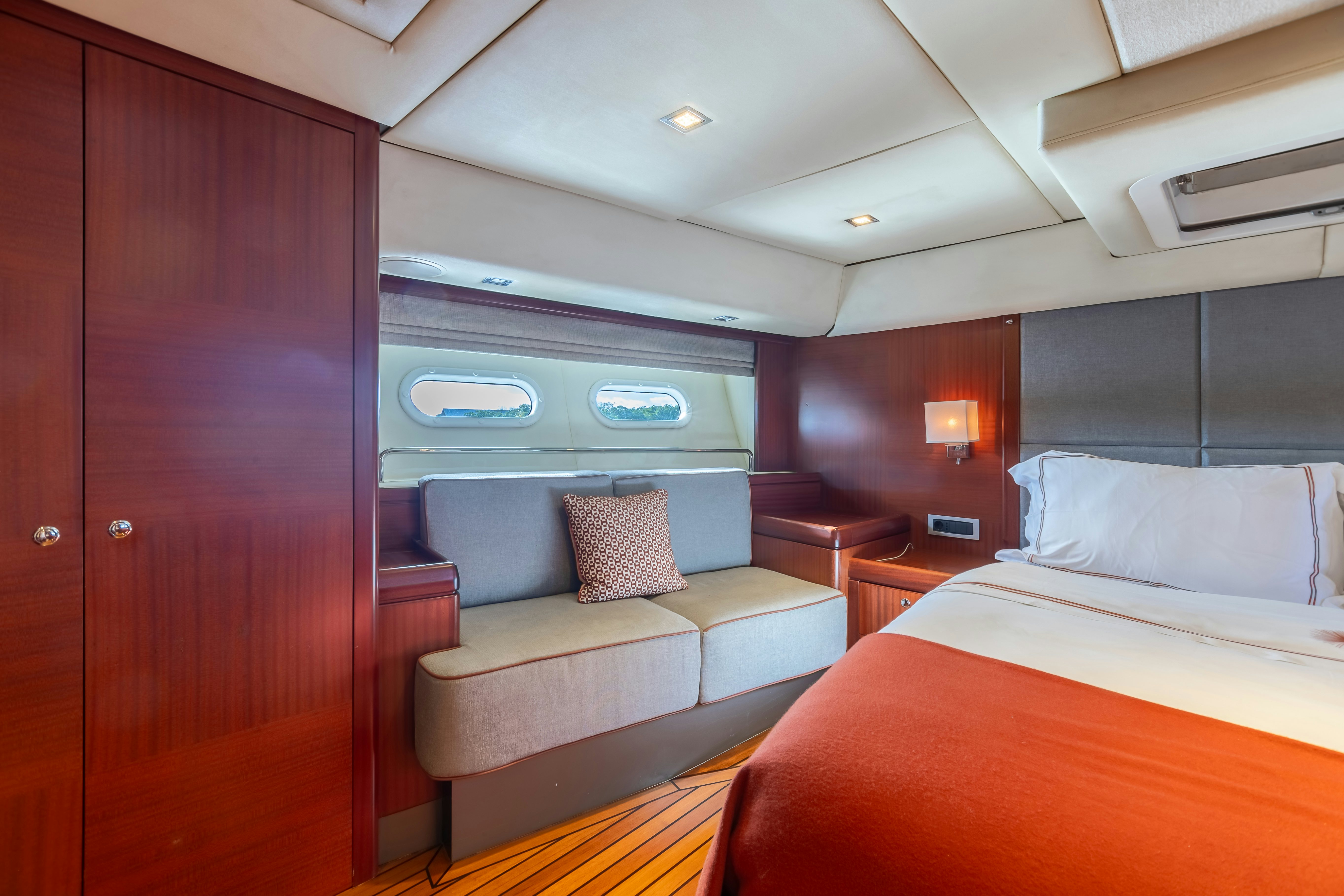 a room with a bed and a couch aboard ASSAI Yacht for Sale