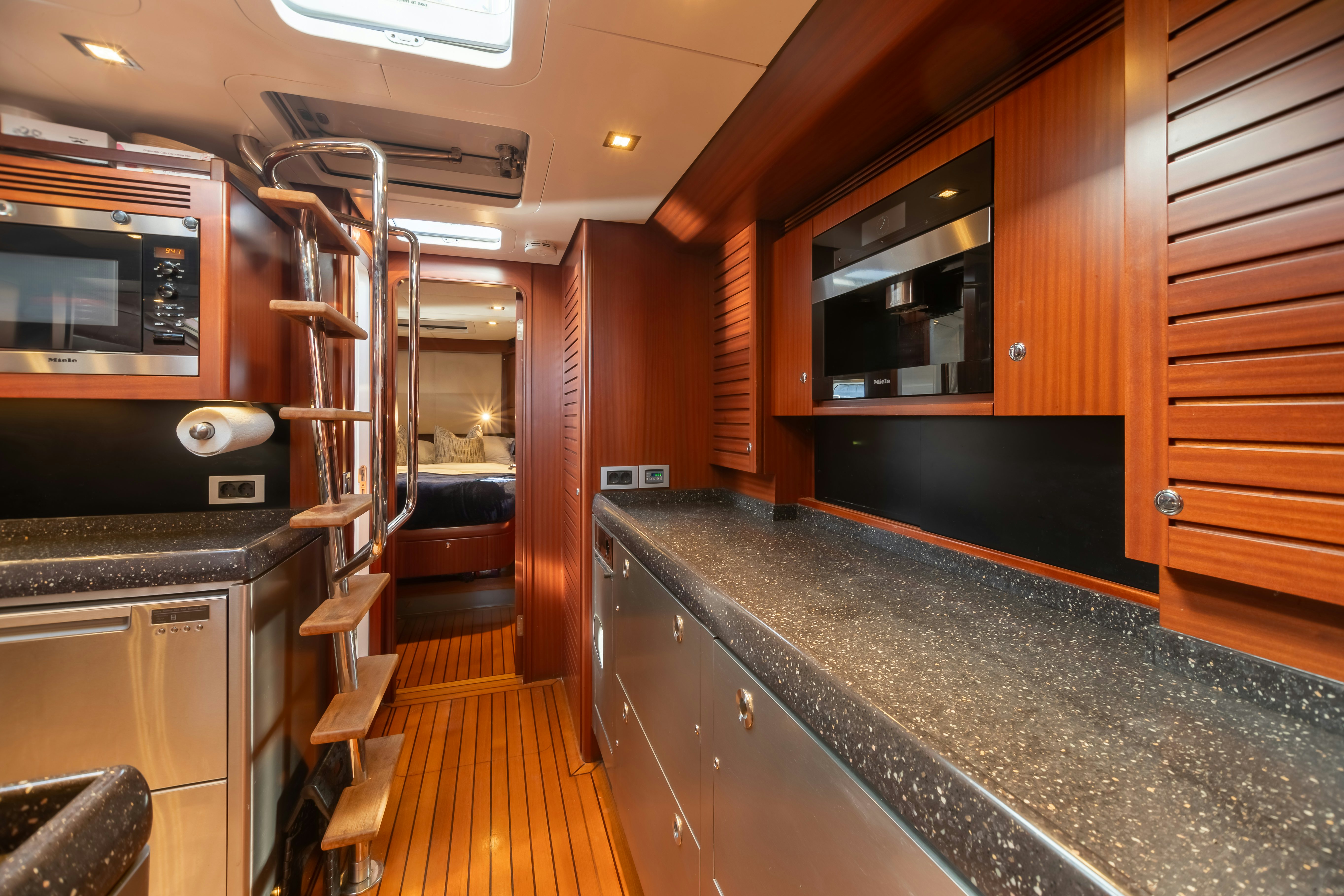 a kitchen with wooden cabinets aboard ASSAI Yacht for Sale