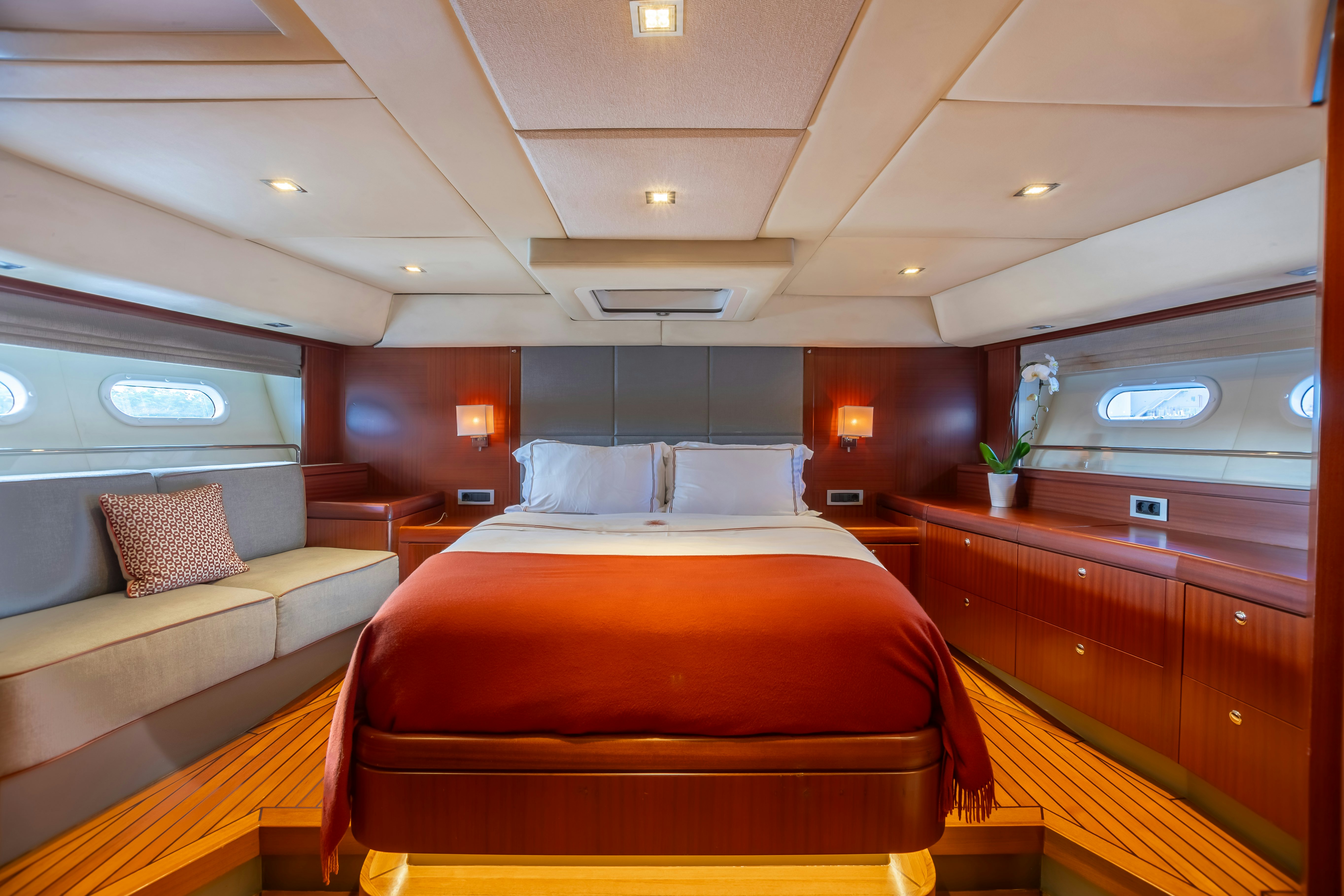 a room with a bed and a couch aboard ASSAI Yacht for Sale