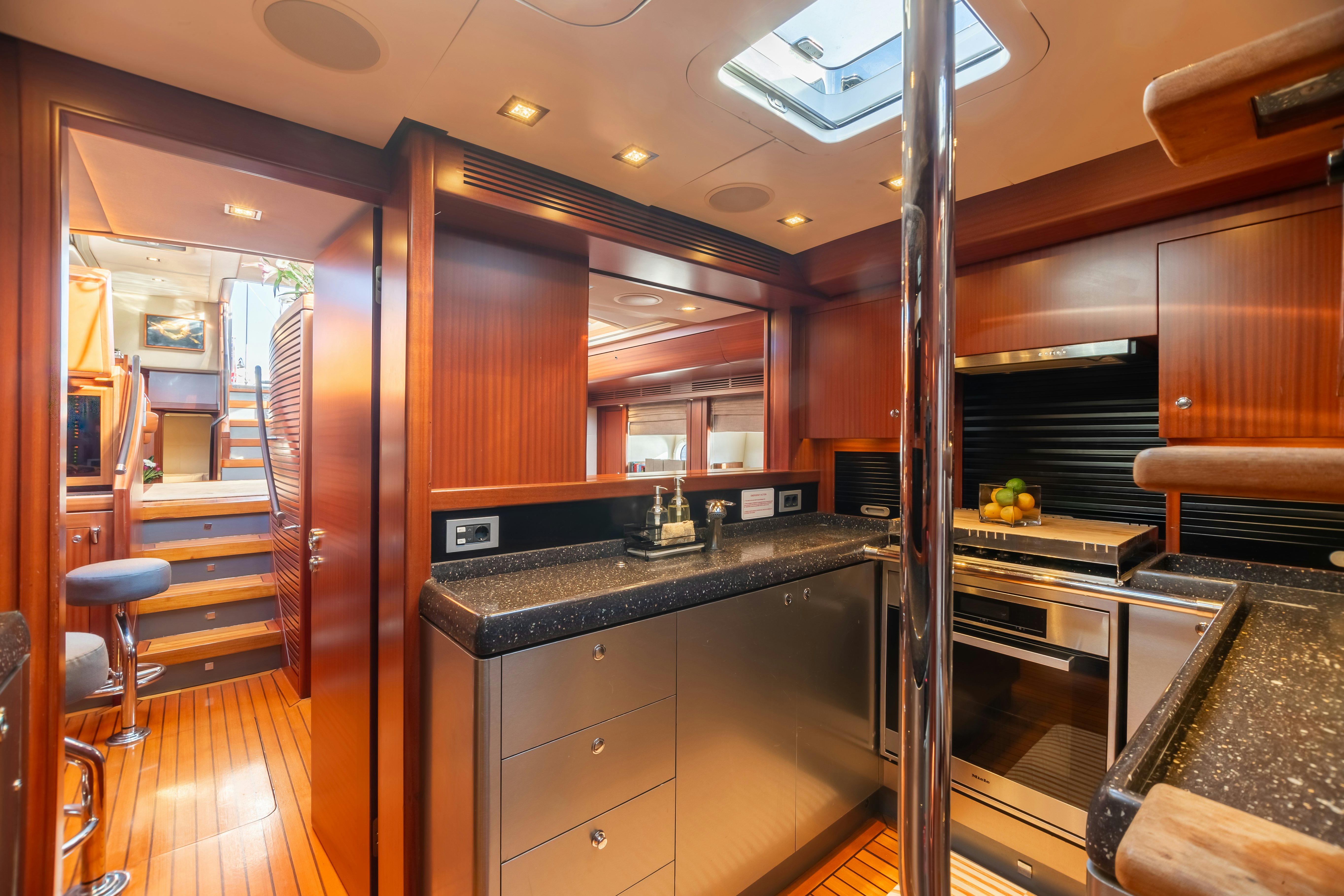 a kitchen with wooden cabinets aboard ASSAI Yacht for Sale