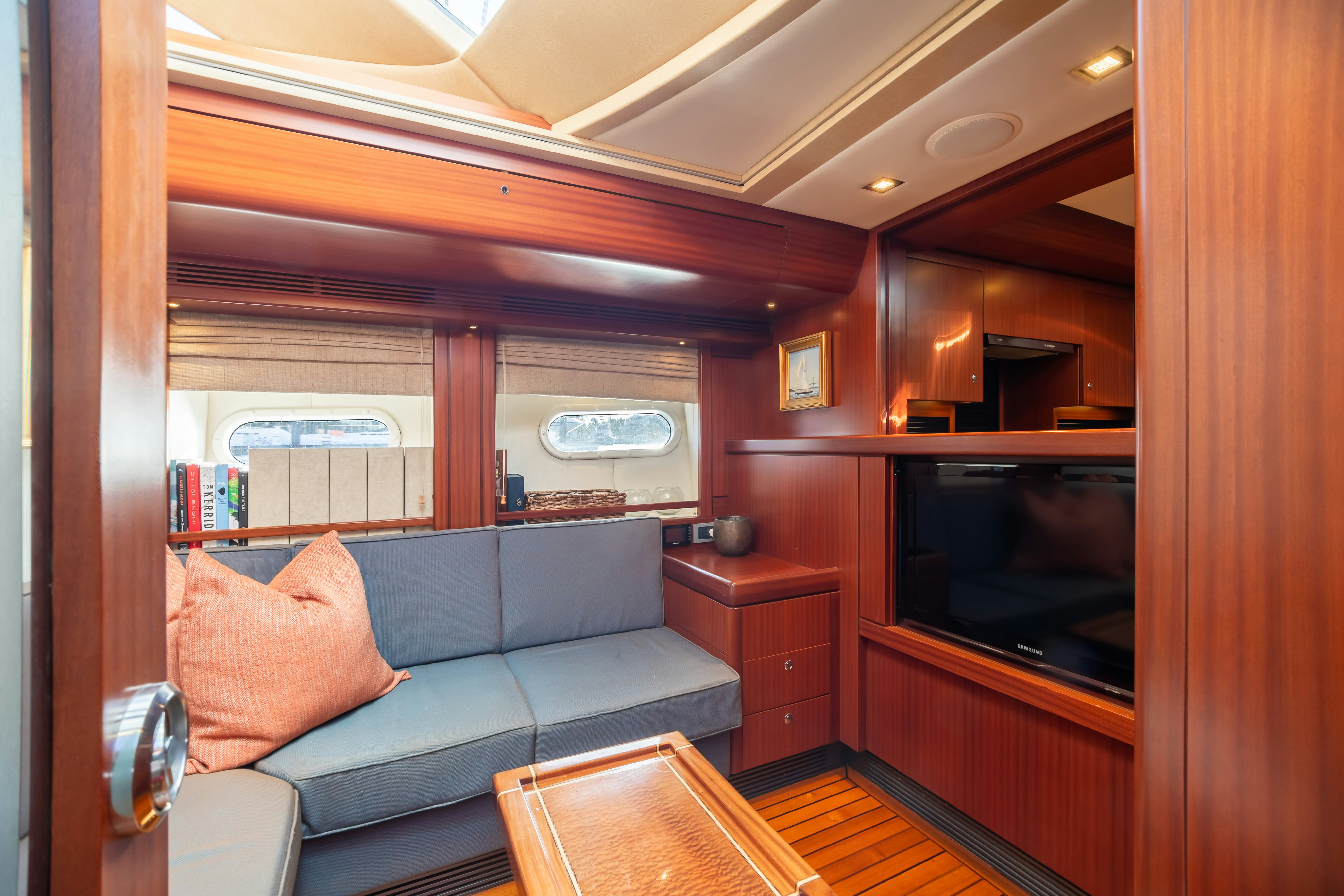 a living room with a couch and a television aboard ASSAI Yacht for Sale