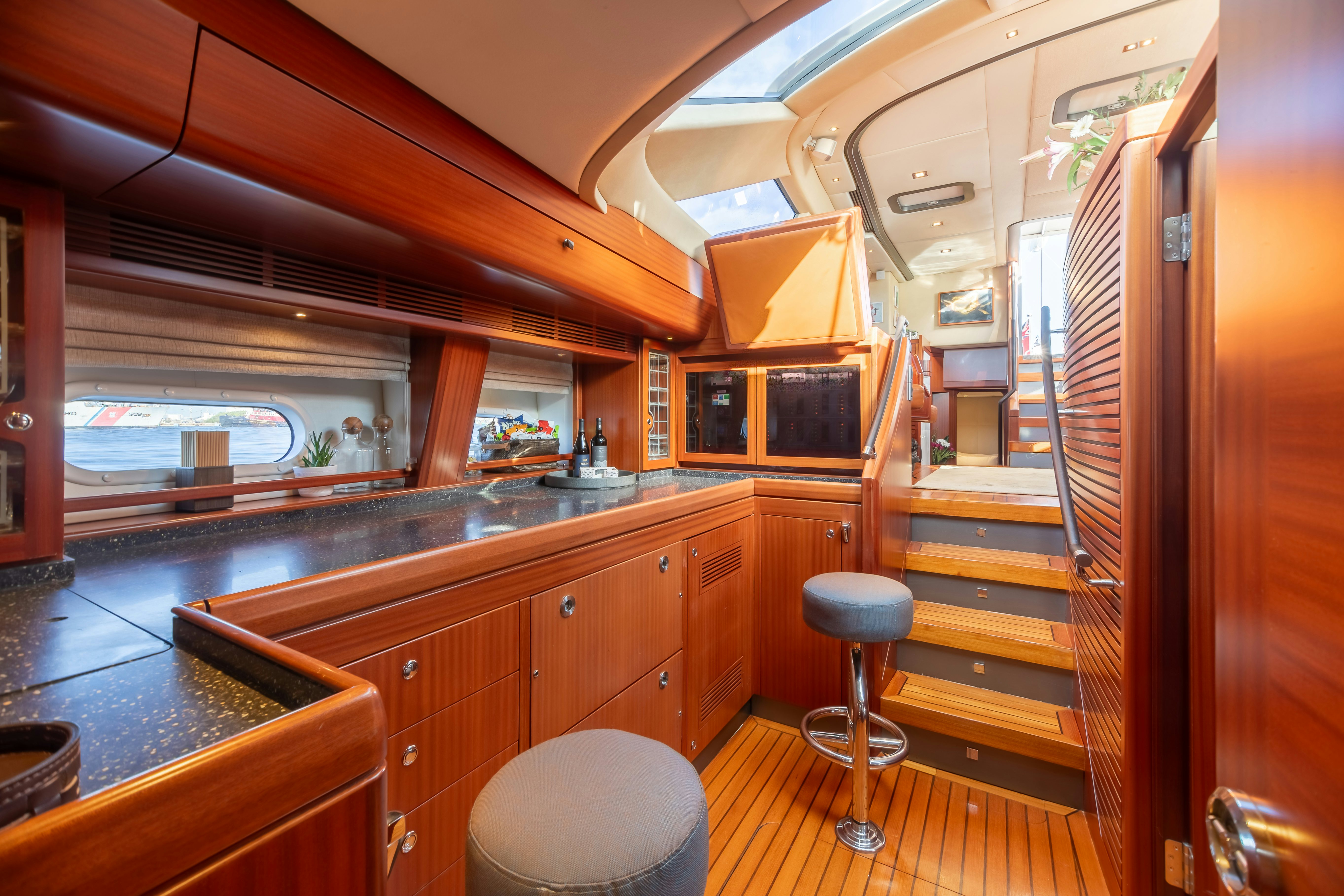a kitchen with wooden cabinets aboard ASSAI Yacht for Sale