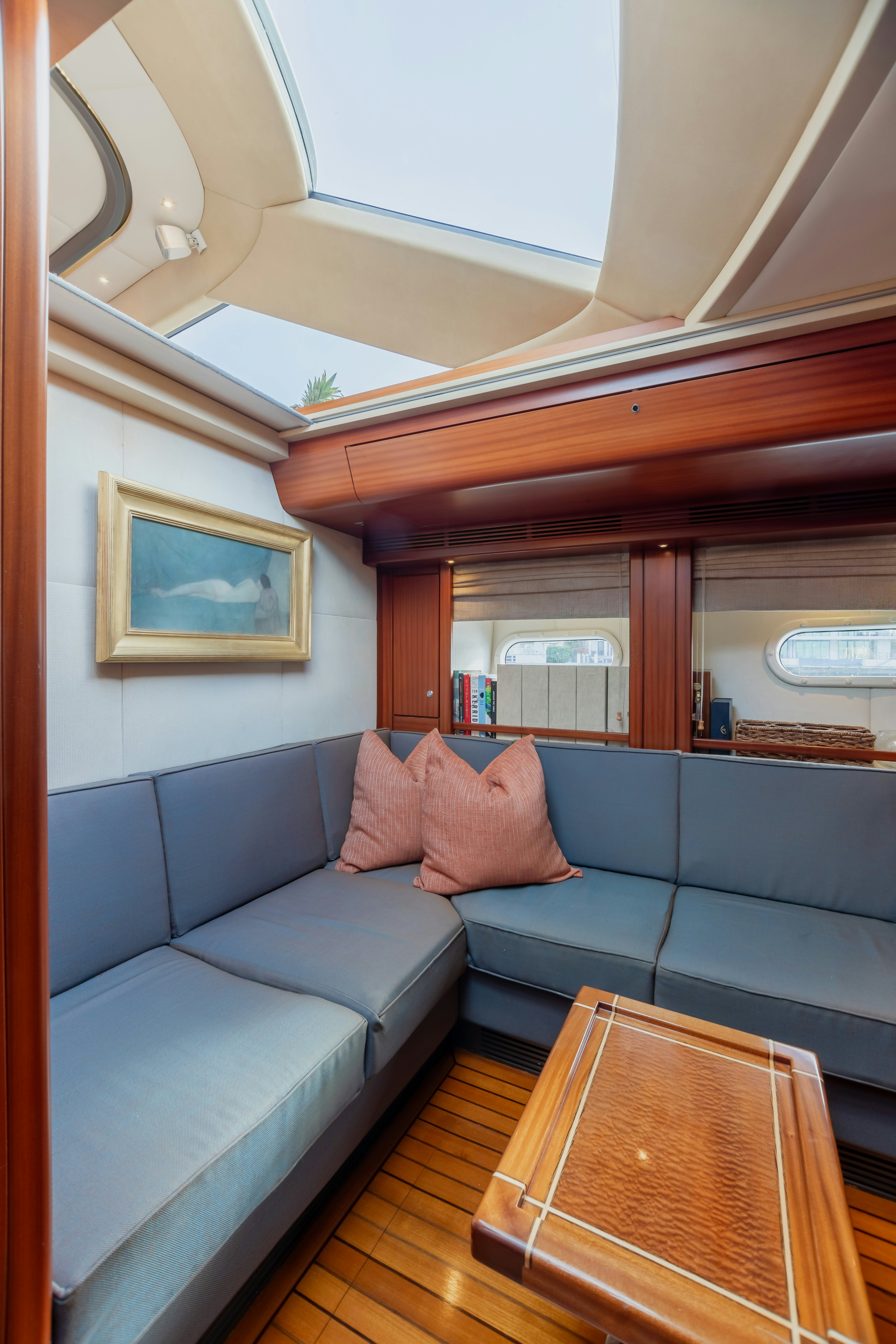 a blue couch in a room aboard ASSAI Yacht for Sale