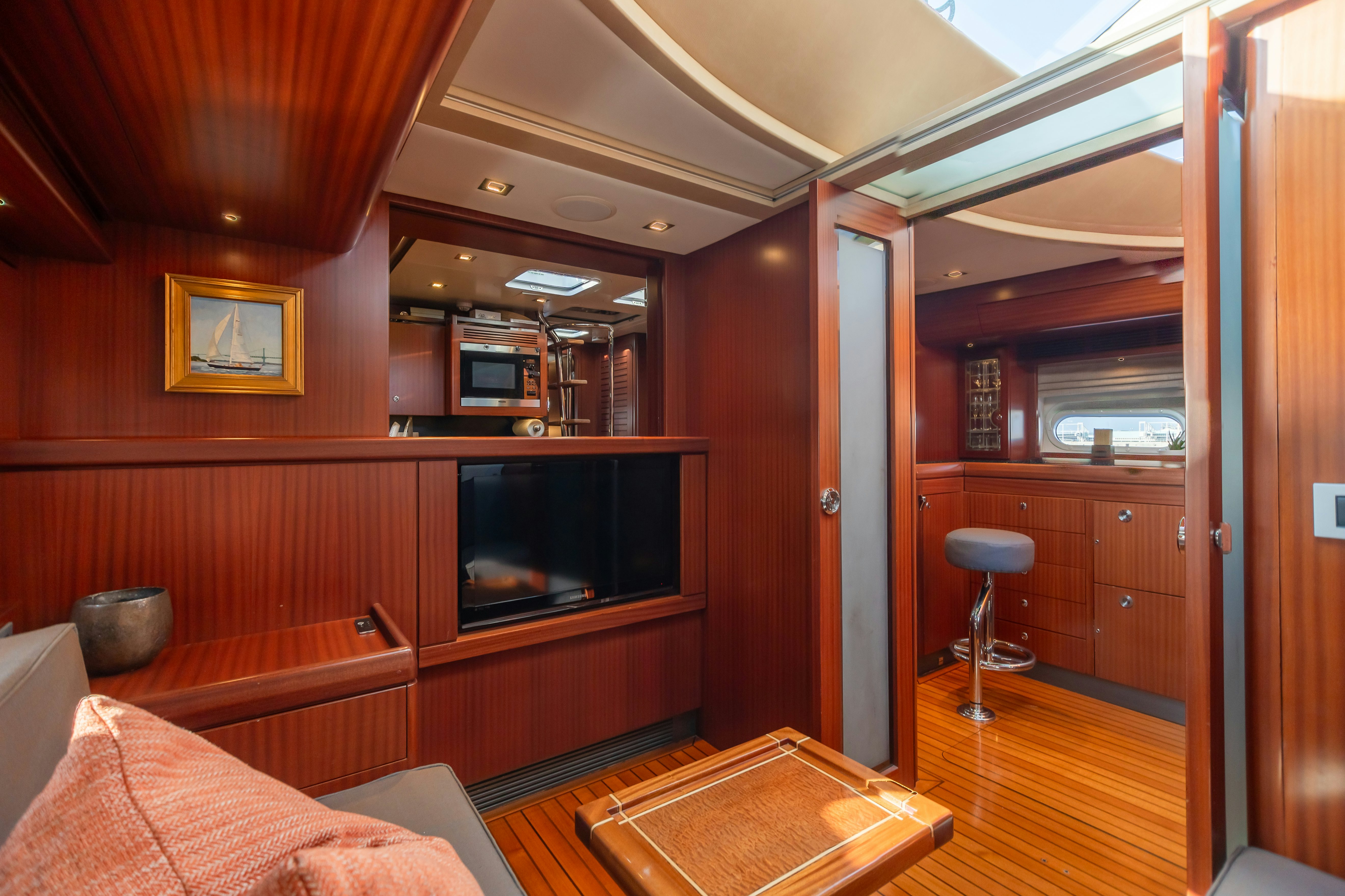 a living room with a wood paneled wall aboard ASSAI Yacht for Sale