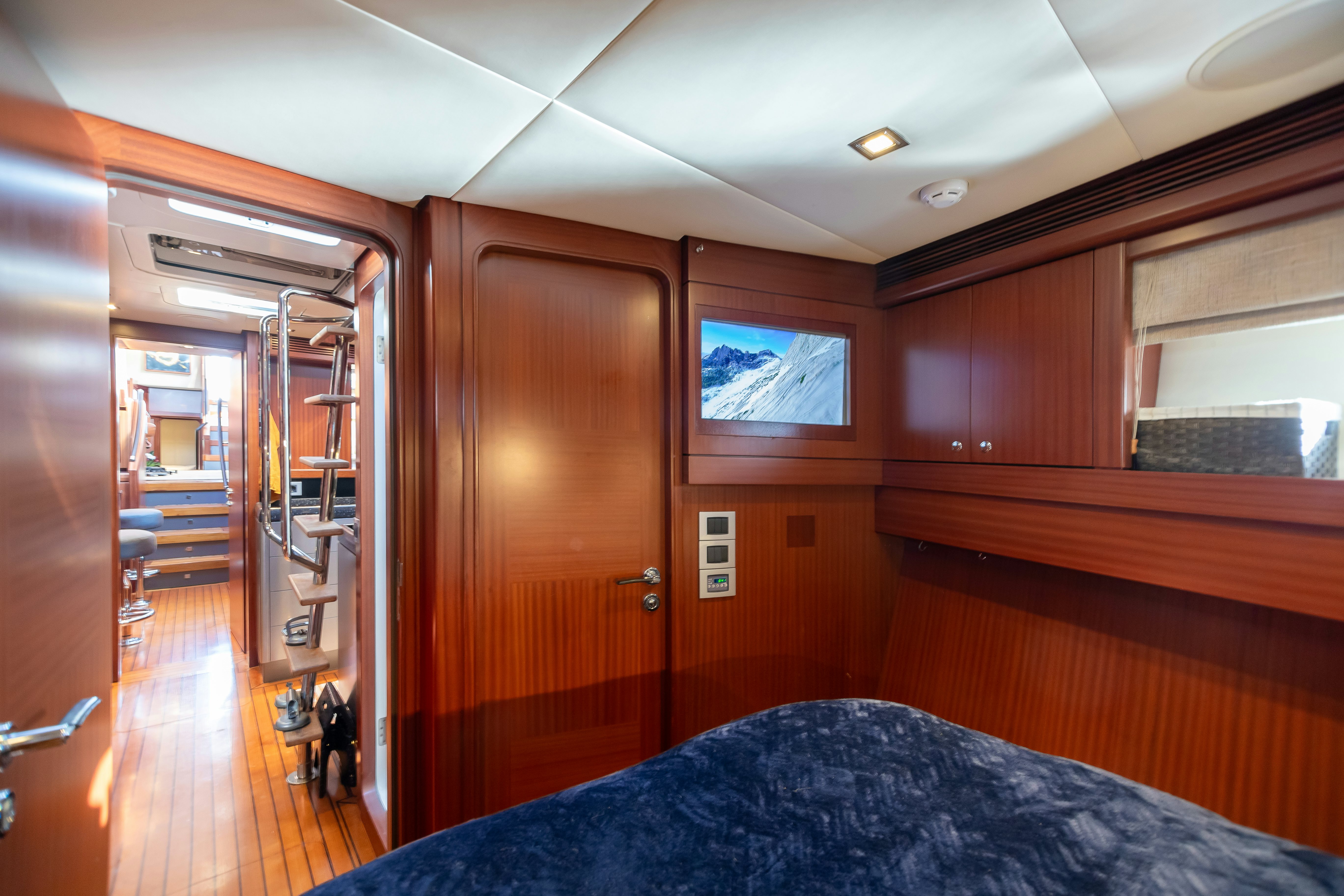 a room with a bed and a door aboard ASSAI Yacht for Sale