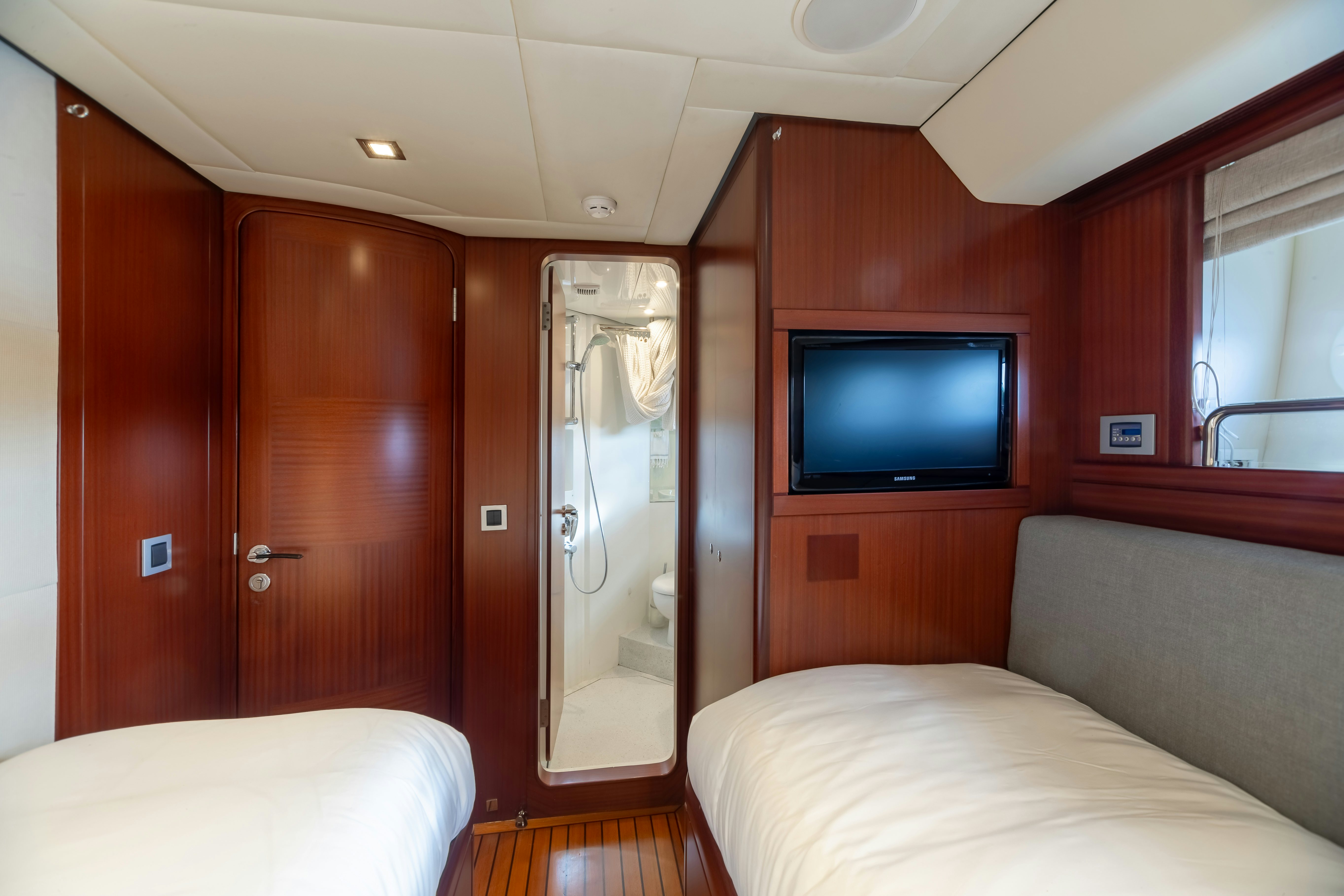 a bedroom with a tv and a bed aboard ASSAI Yacht for Sale