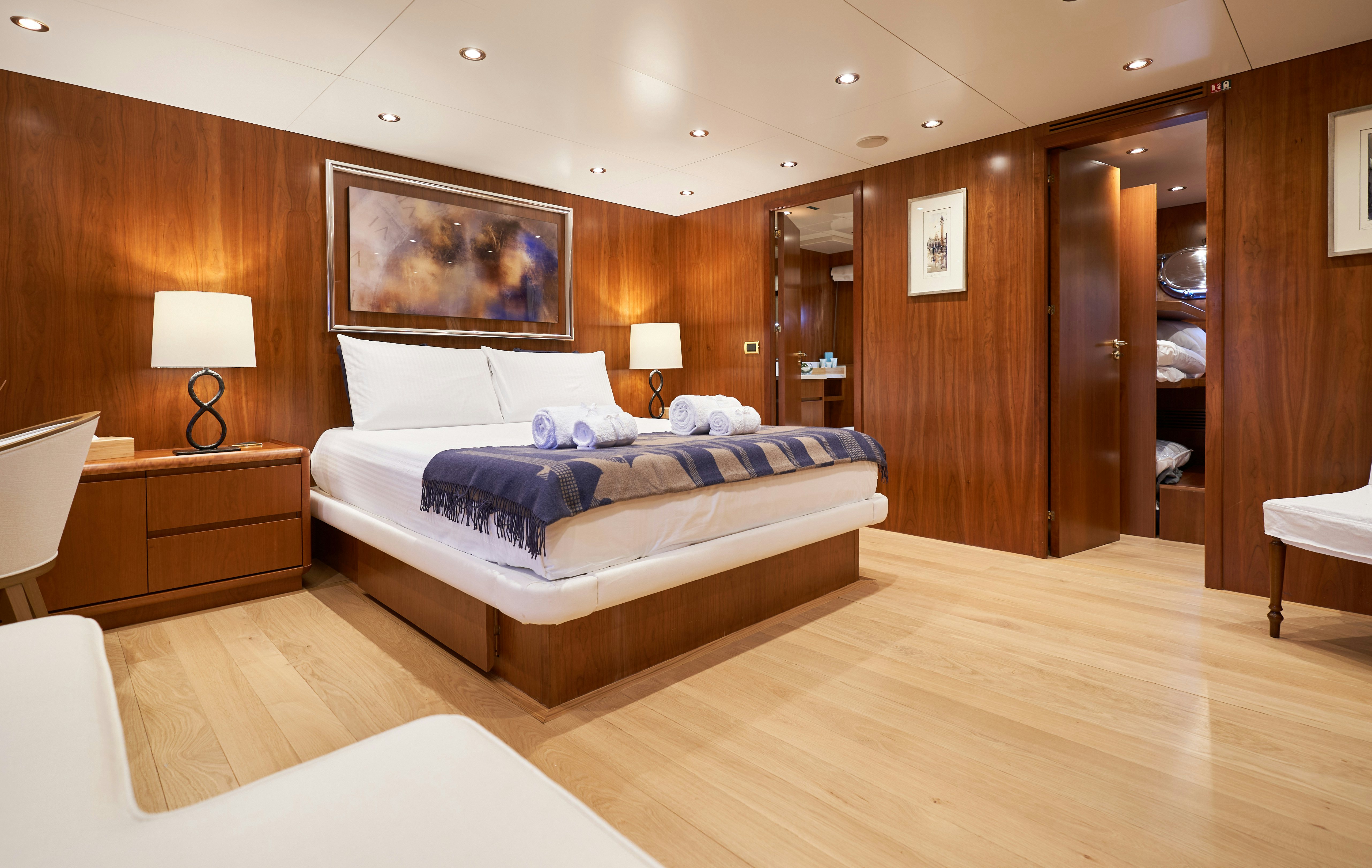 a hotel room with a bed and a desk aboard L'INSTANT IV Yacht for Sale