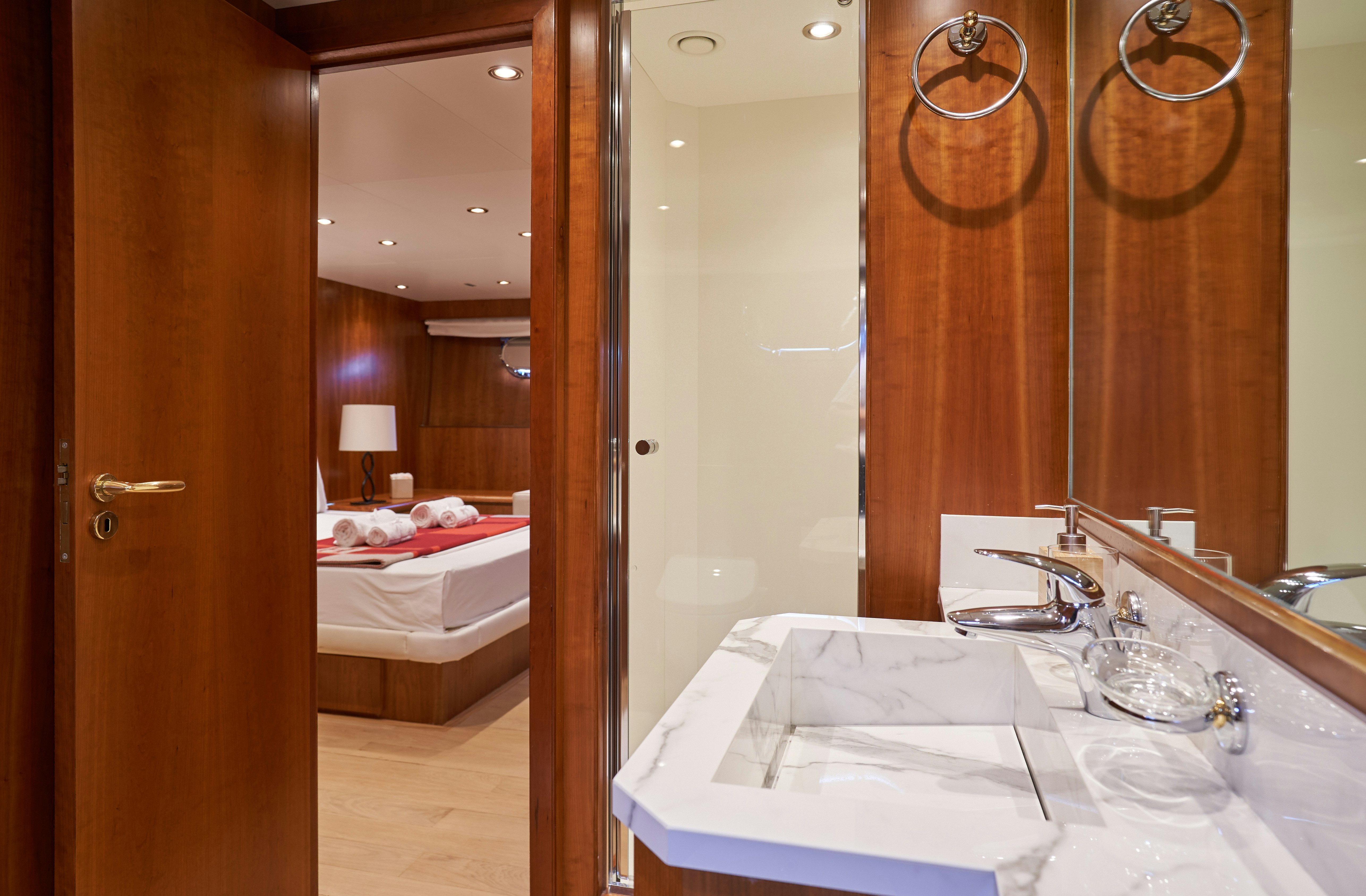 a bathroom with a large mirror aboard L'INSTANT IV Yacht for Sale