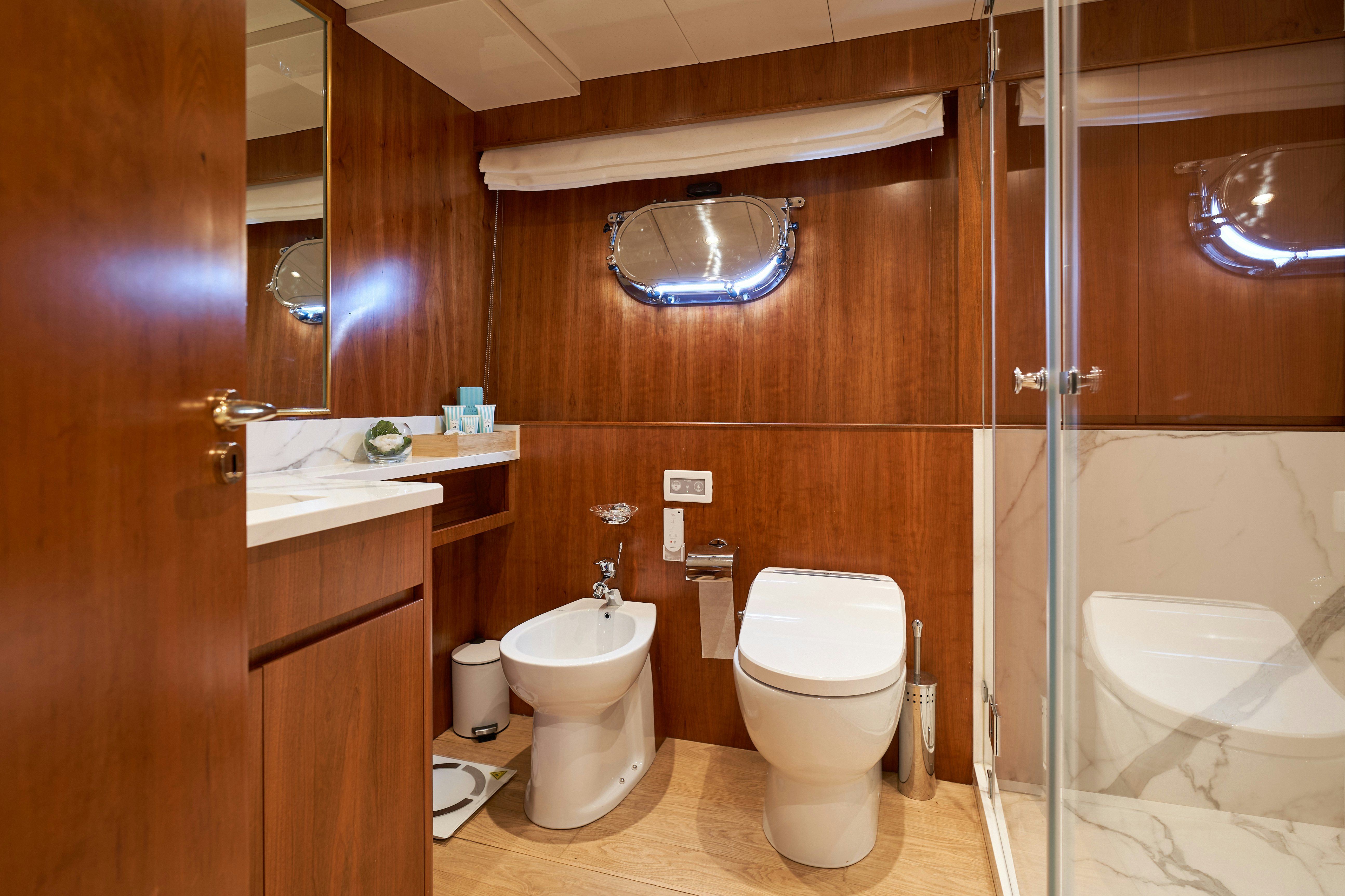 a bathroom with a glass shower aboard L'INSTANT IV Yacht for Sale