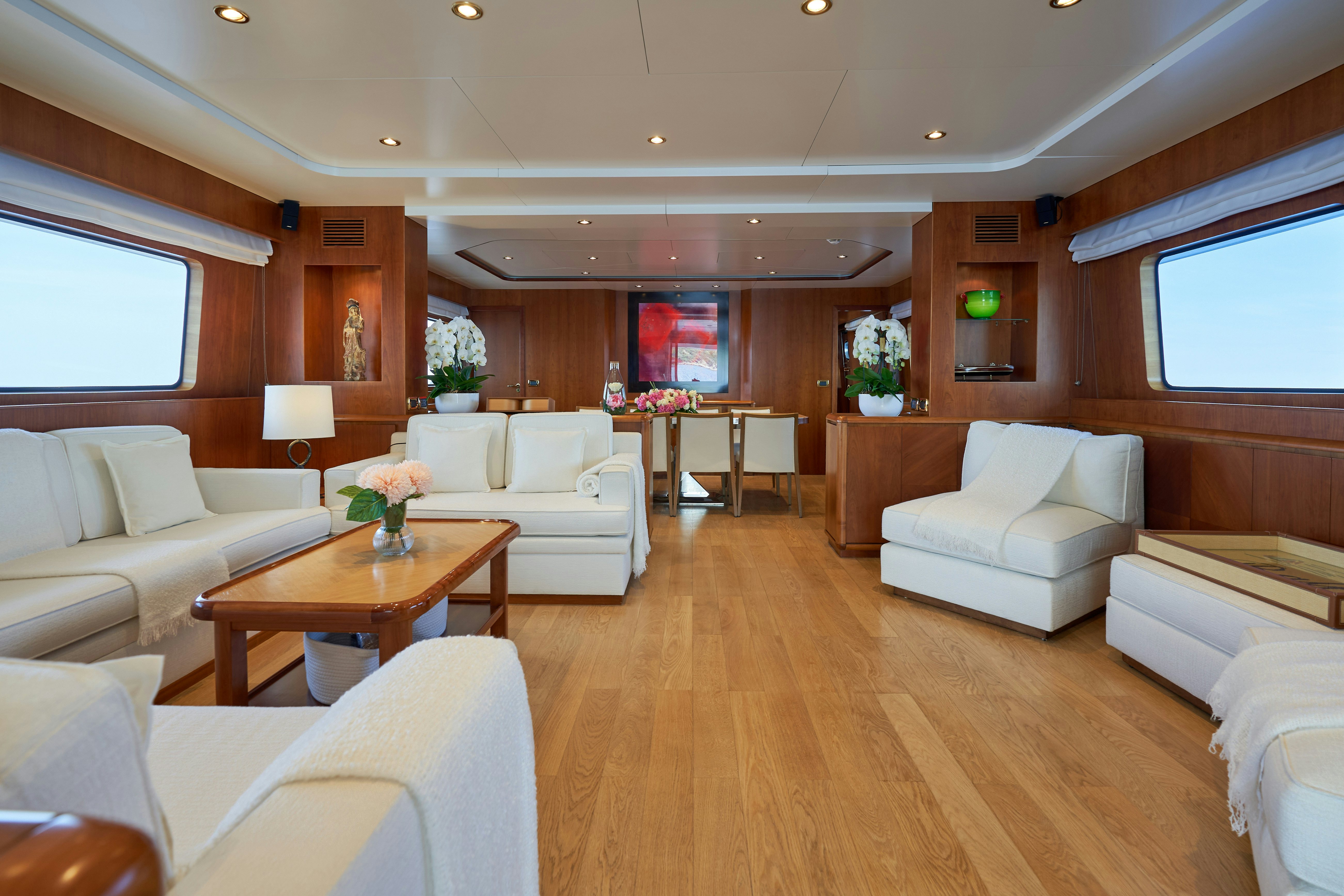 a living room with a wood floor aboard L'INSTANT IV Yacht for Sale